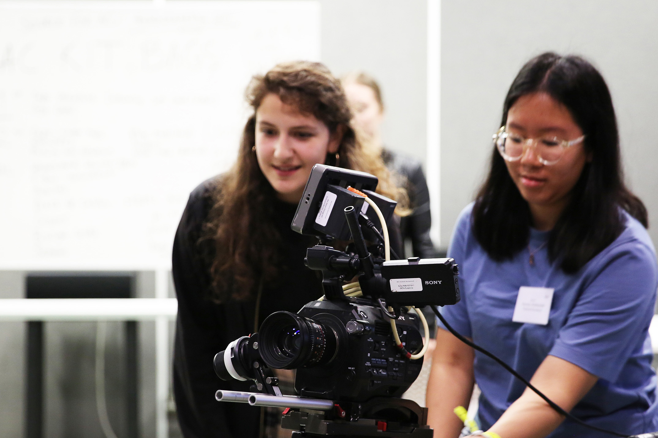 Young students using camera equipment to make a film