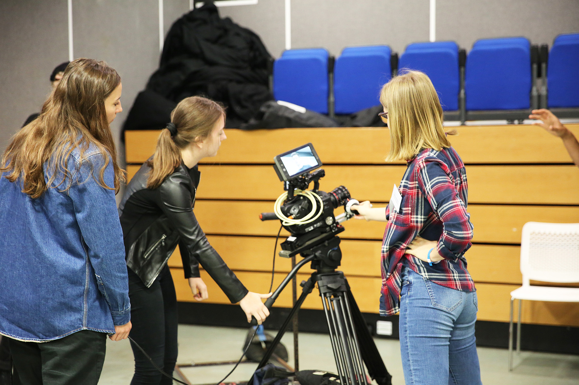 Young students using camera equipment to make a film
