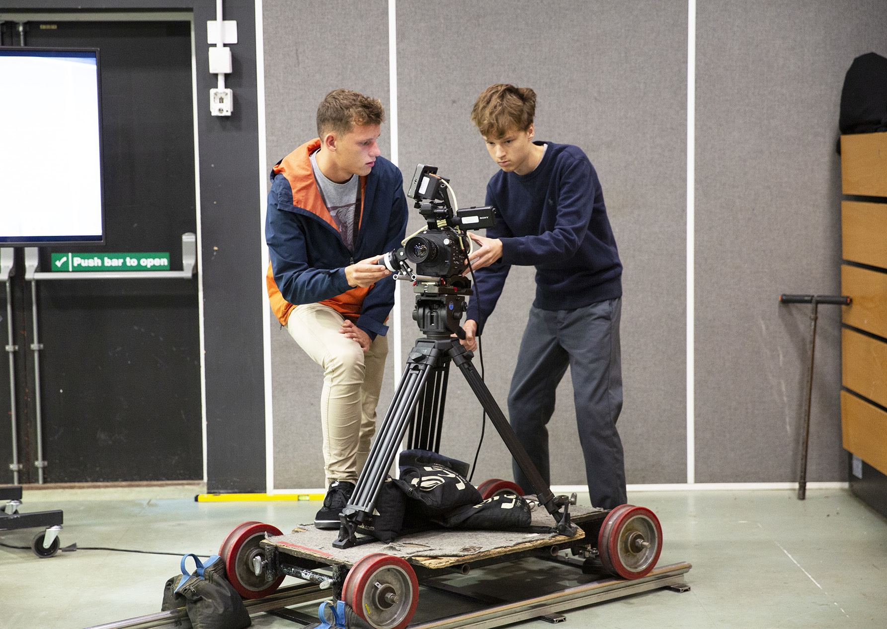 Young students using camera equipment to make a film