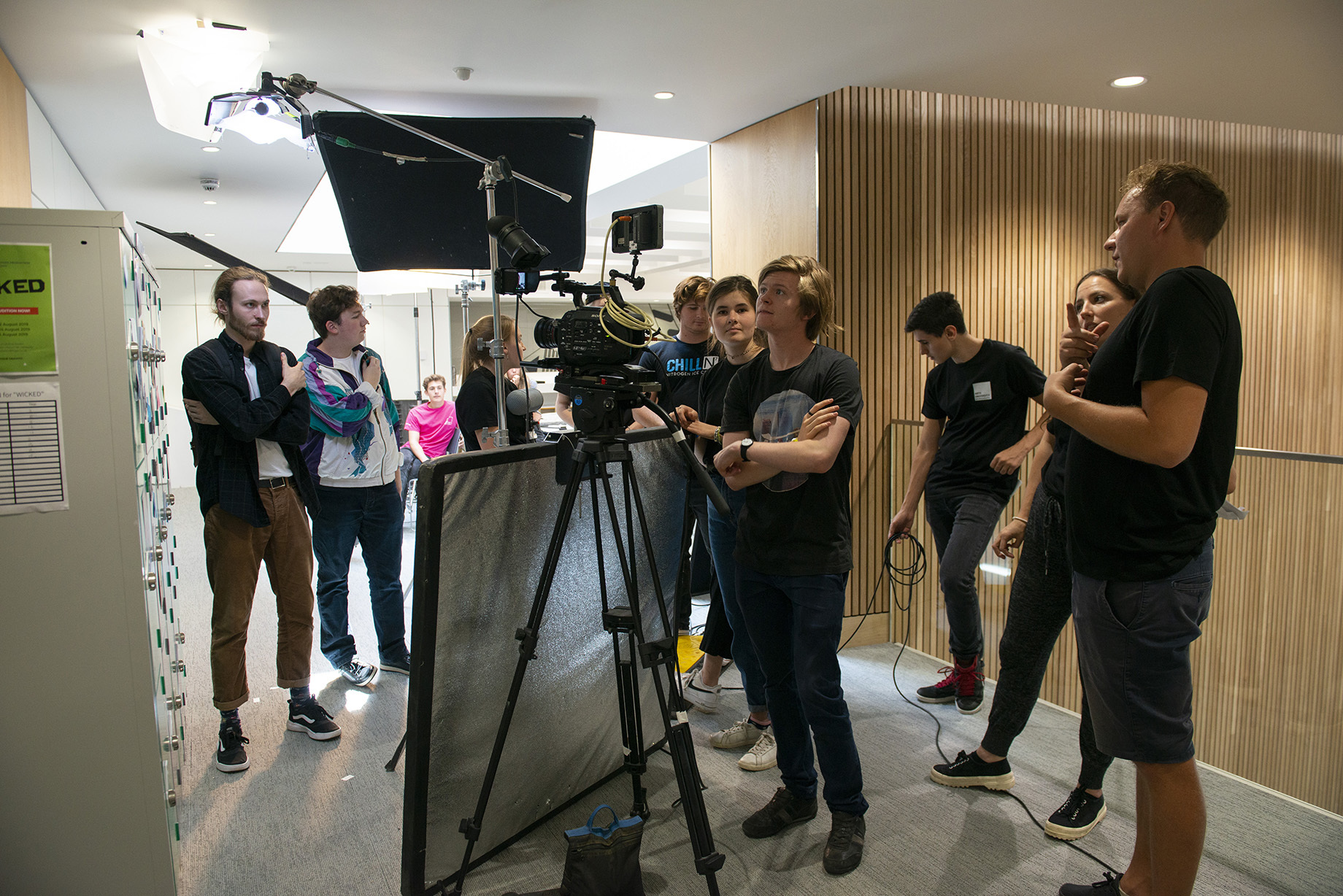 Young students using camera equipment to make a film