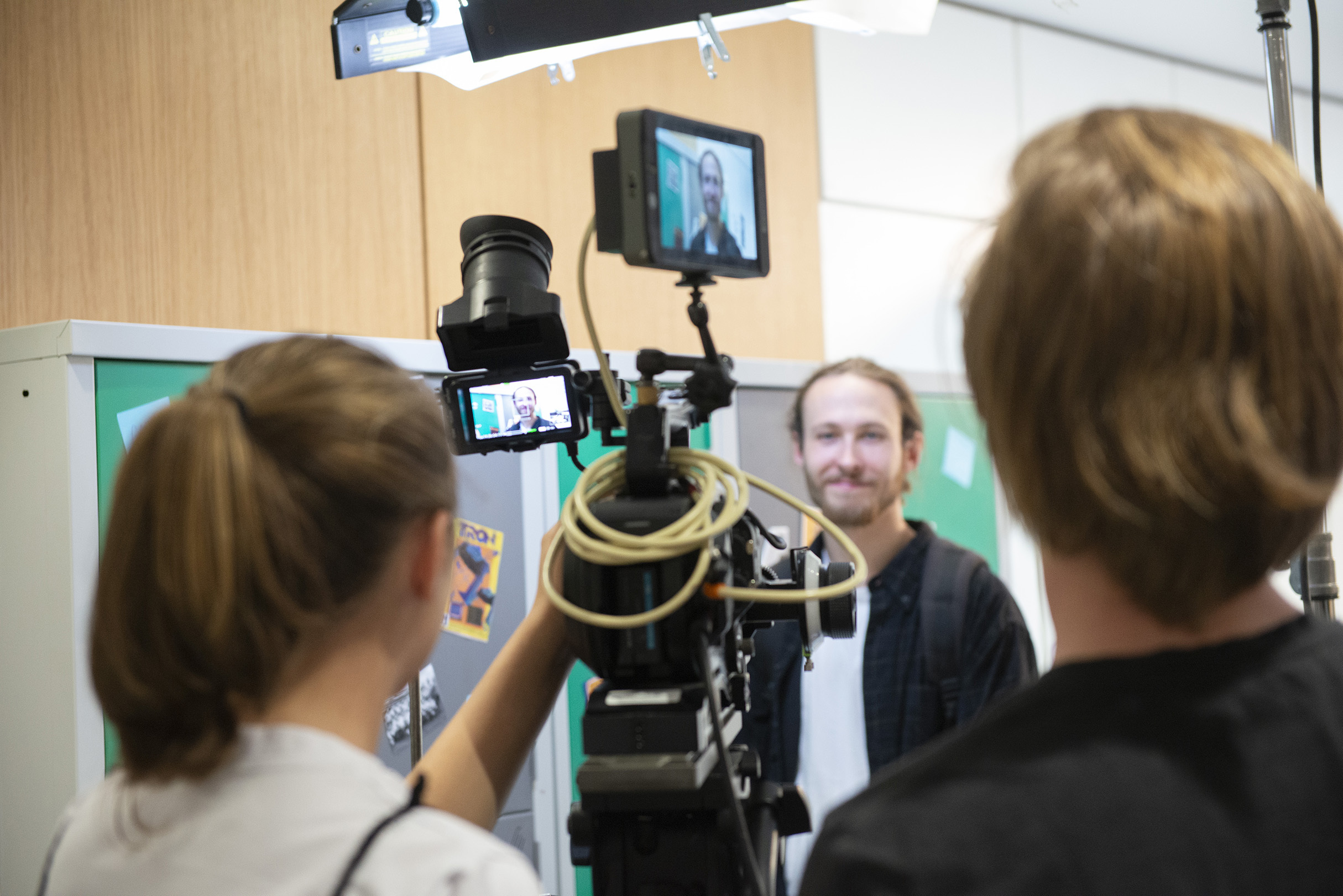 Young students using camera equipment to make a film