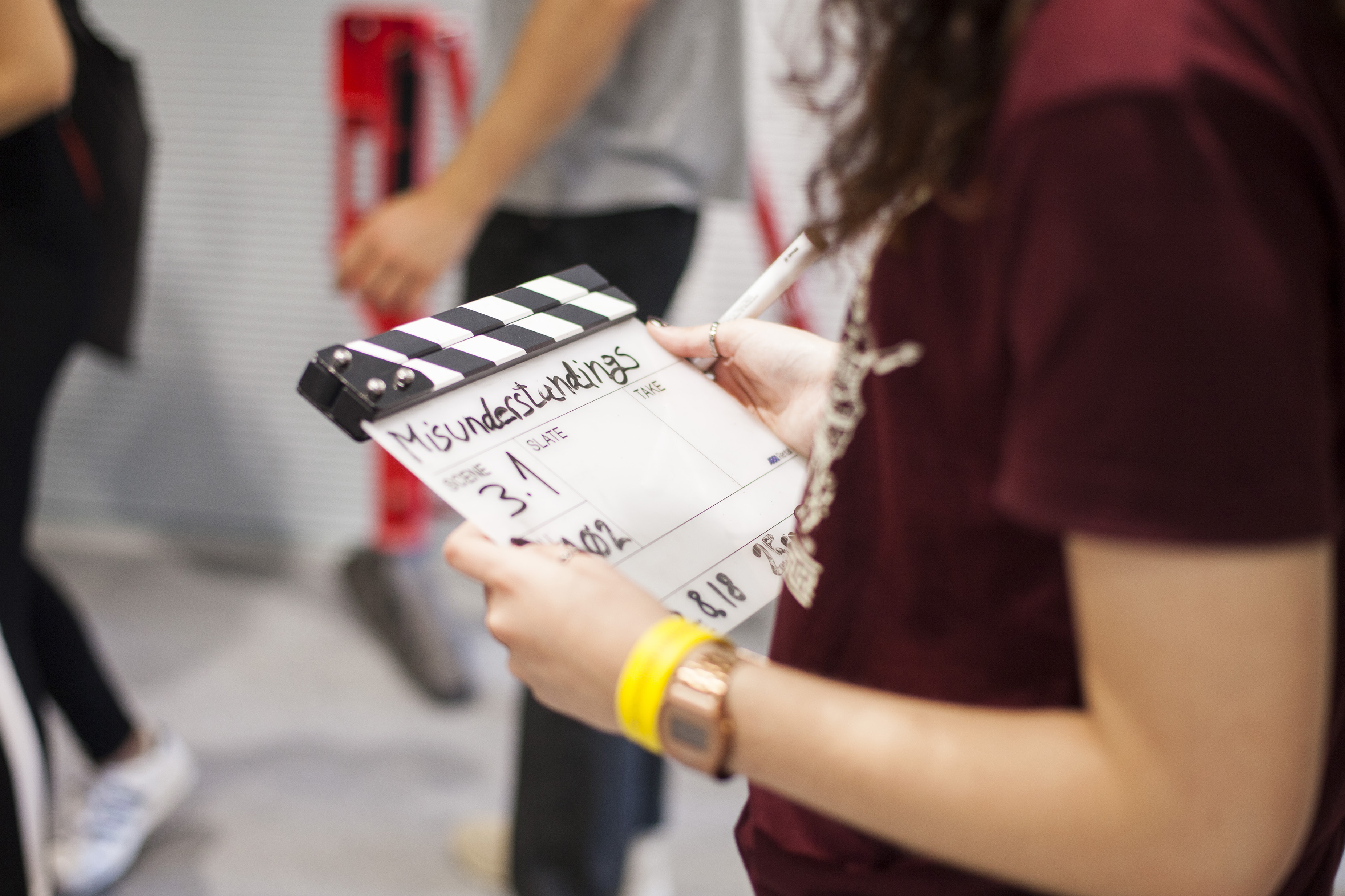 Young students using camera equipment to make a film
