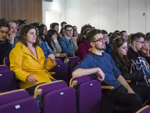 Members of an audience sitting in a lecture theatre