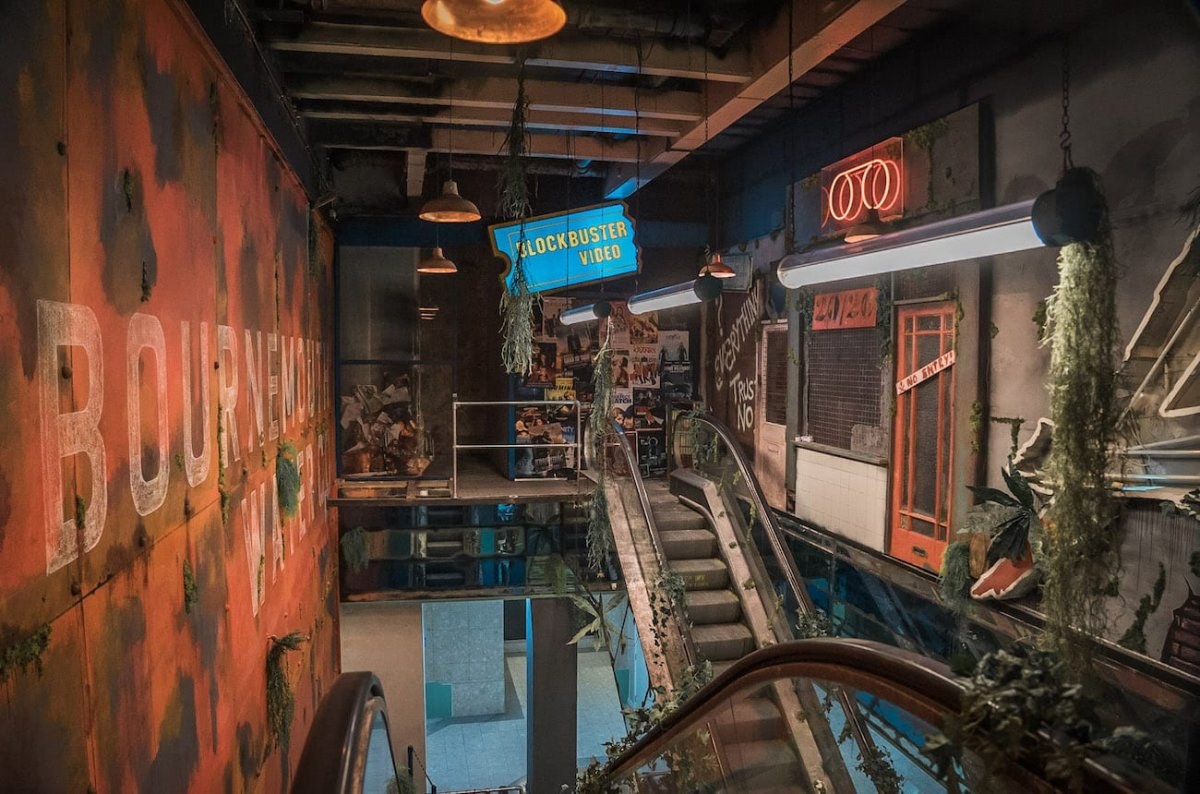 Interior of the Syrup Room at The Avenue in Bournemouth, with two escalators leading up to short landings.
