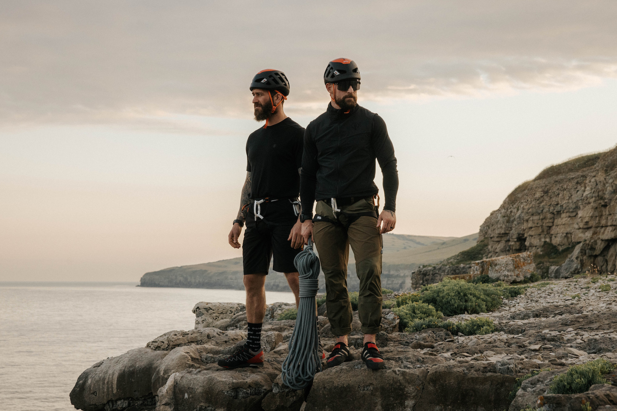 L. Tinsley and A. Stazicker standing on a cliff edge.