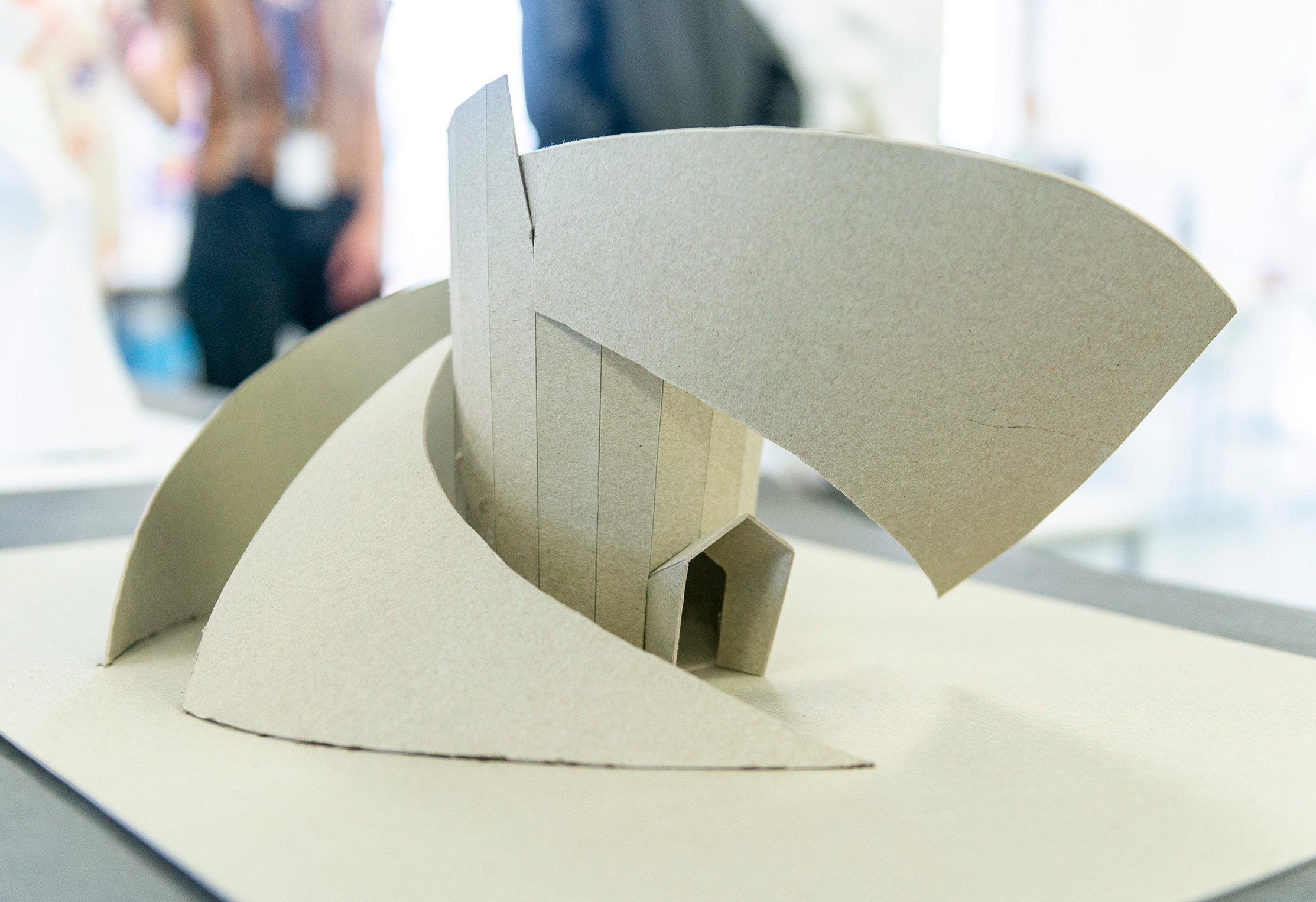 A cardboard architectural model sitting on a table.