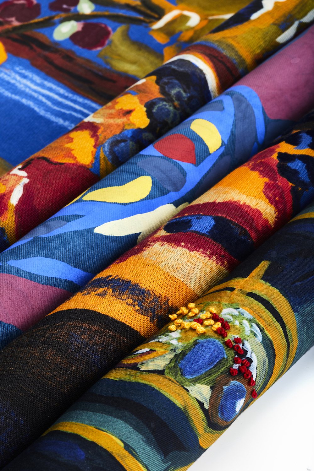 Rolls of colourful textile patterns.