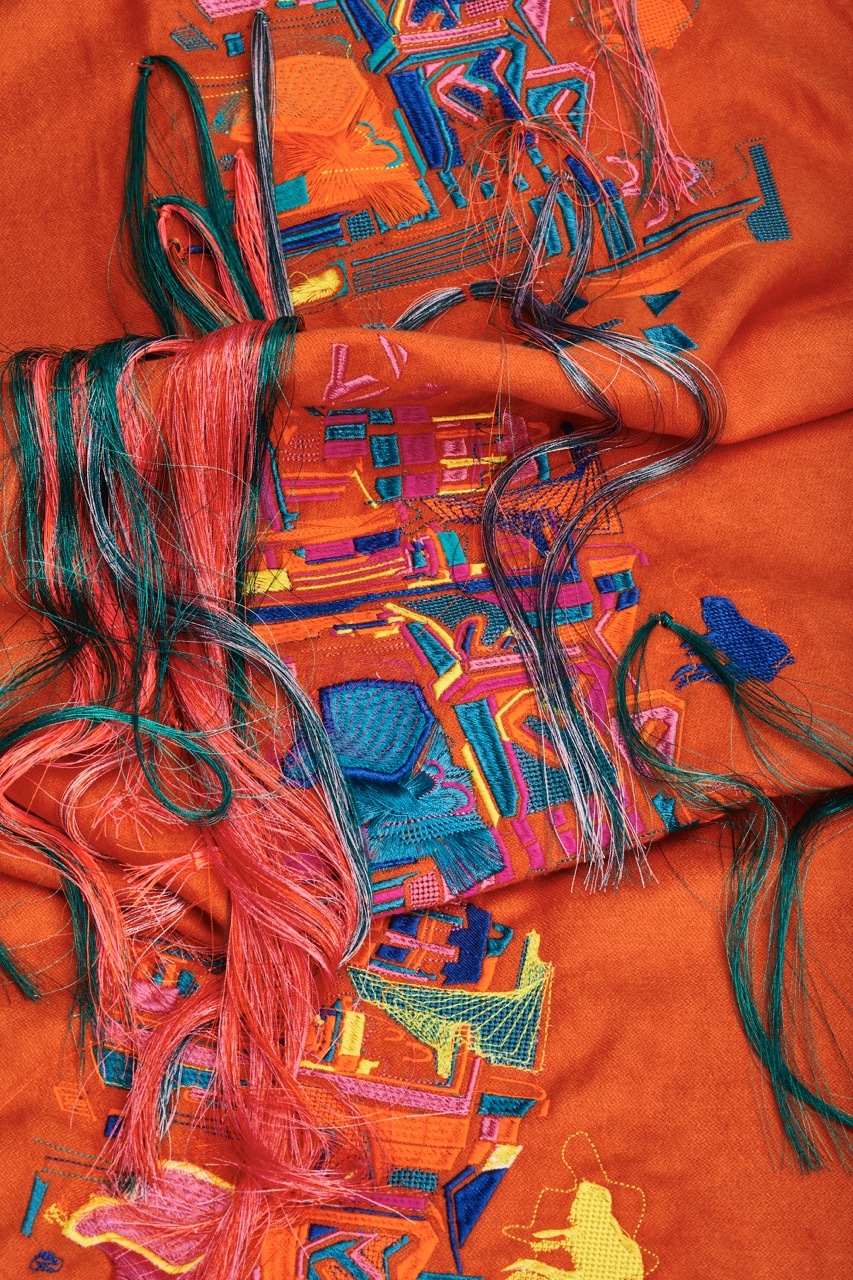Red patterned textiles with embroidered hair textures.