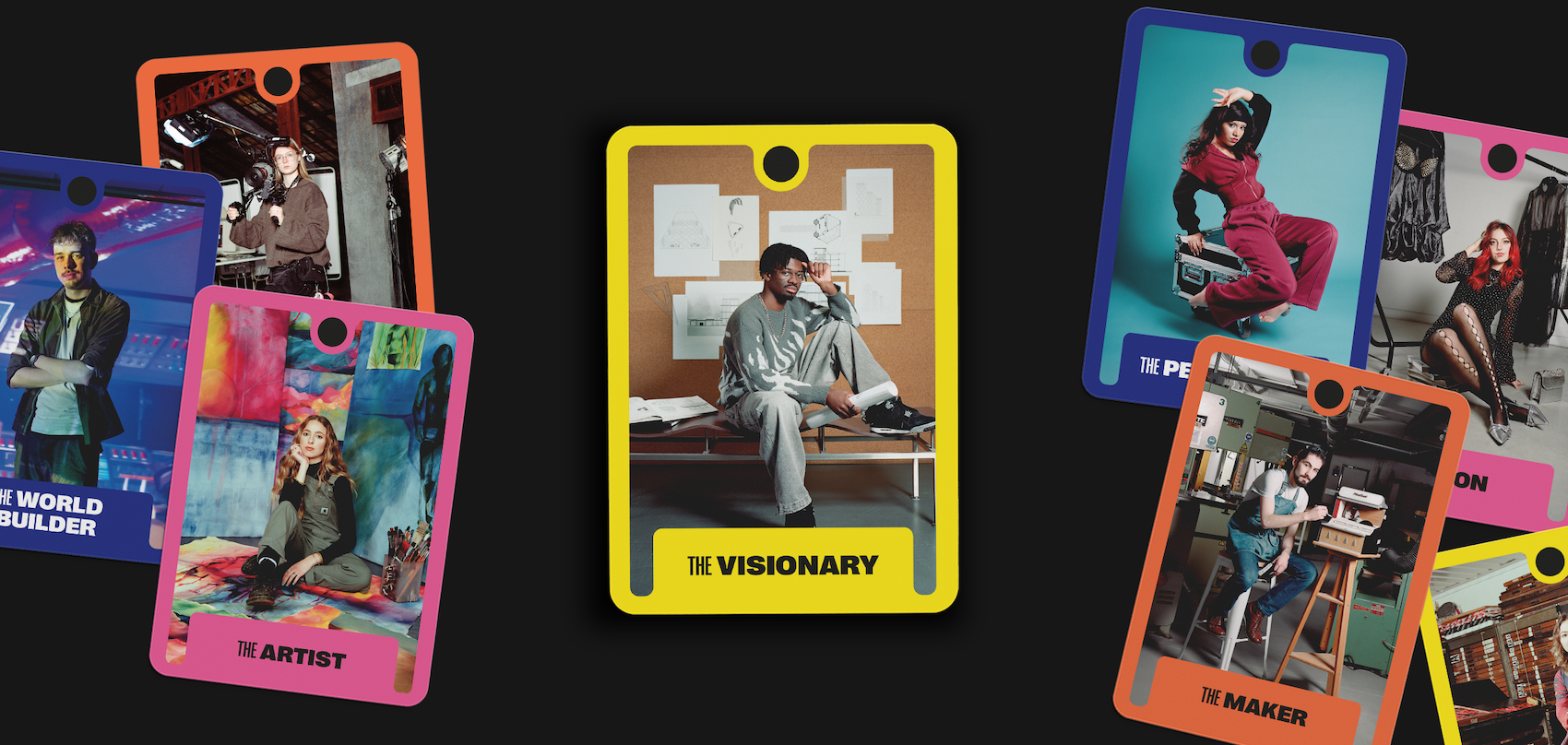 Colourful tarot-style cards scattered on black background featuring portraits in yellow, orange, pink, and blue frames with titles like "The Visionary" and "The Artist".