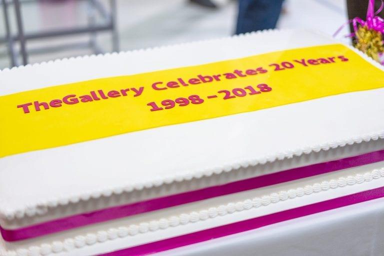 A cake with the words "TheGallery Celebrates 20 Years 1998-2018" iced on top.