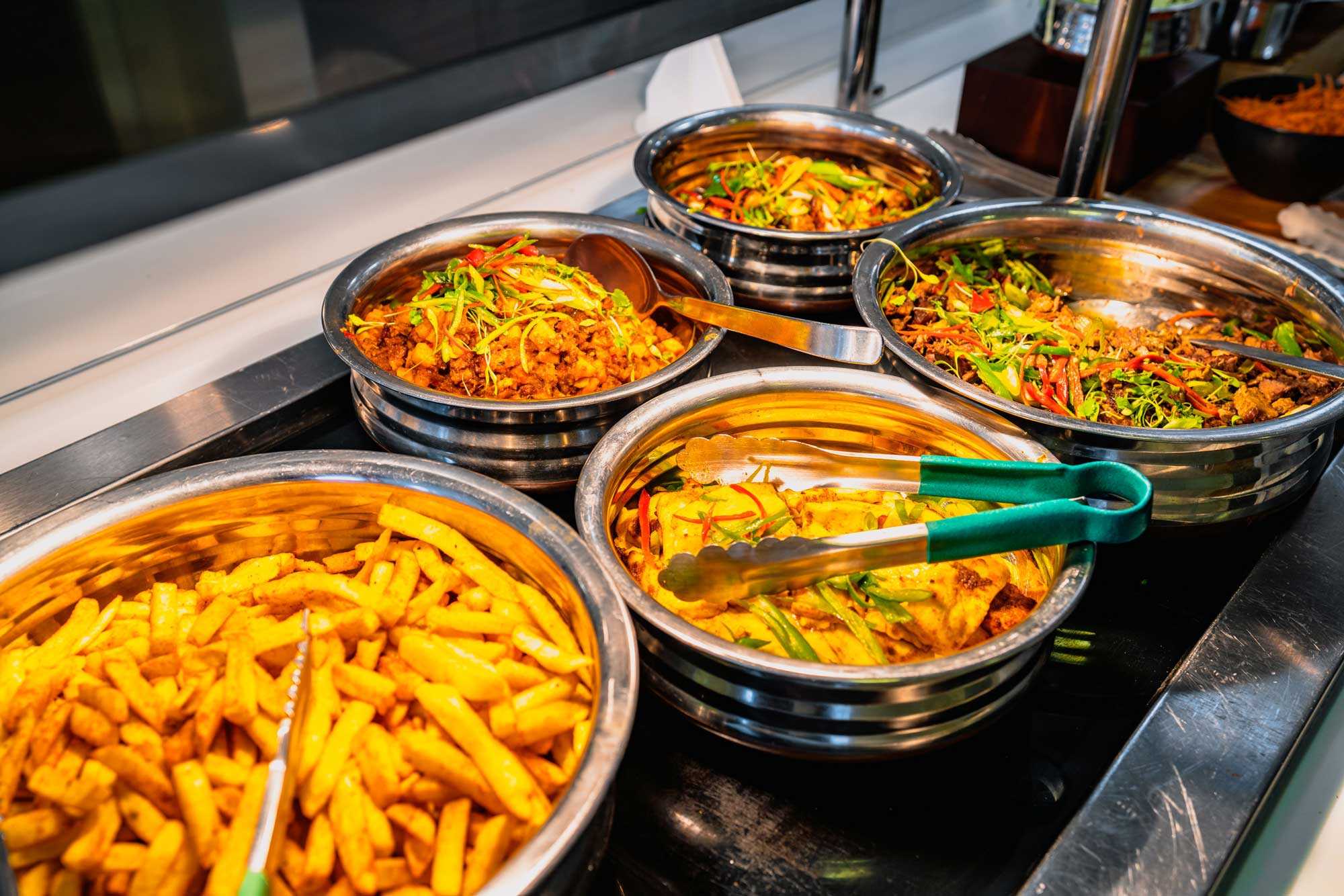 Image of The Refectory displaying lunch options, with hot chips and cooked veggies in pots