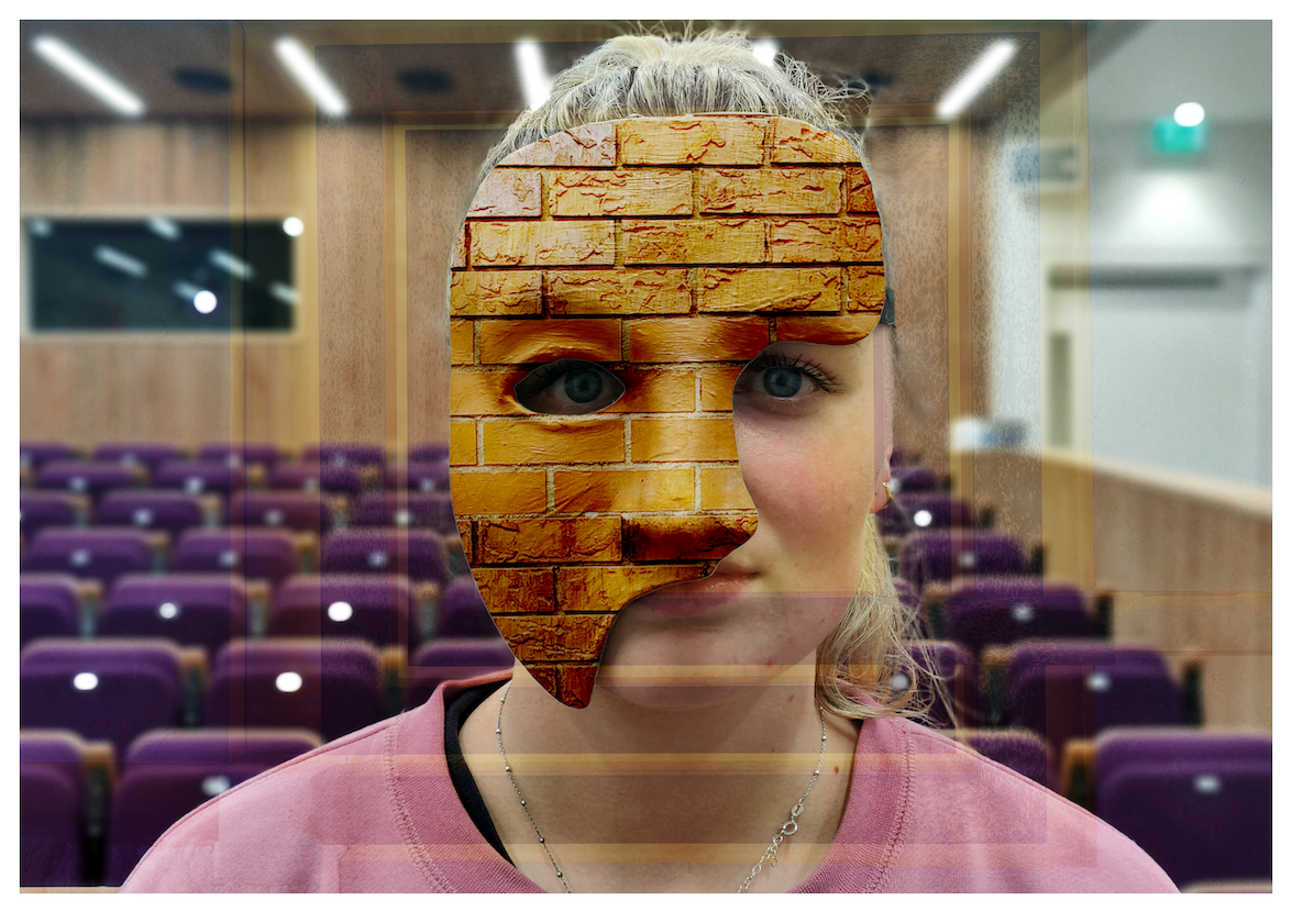 Close-up of a girl standing in a lecture theatre wearing a partial mask with a brick wall design.