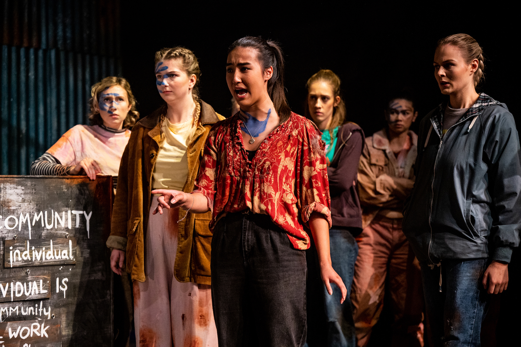 A group of six BA (Hons) Acting students gathered together while performing "This Changes Everything". The actor in the centre is speaking.