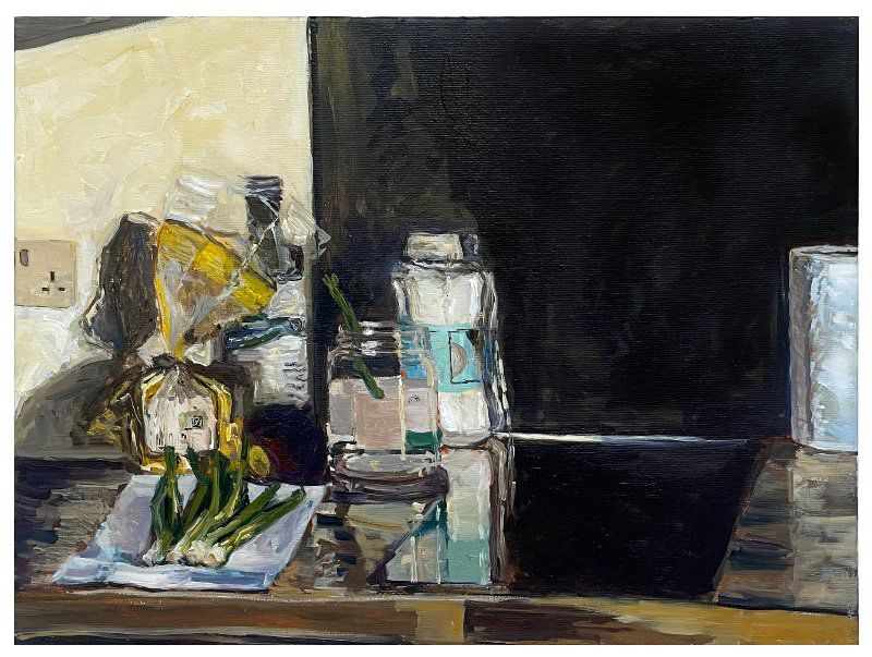 Oil painting of a kitchen side with vegetables drying on a tea towel next to a stove, with caddies of sugar, oil and kitchen paper in the background.