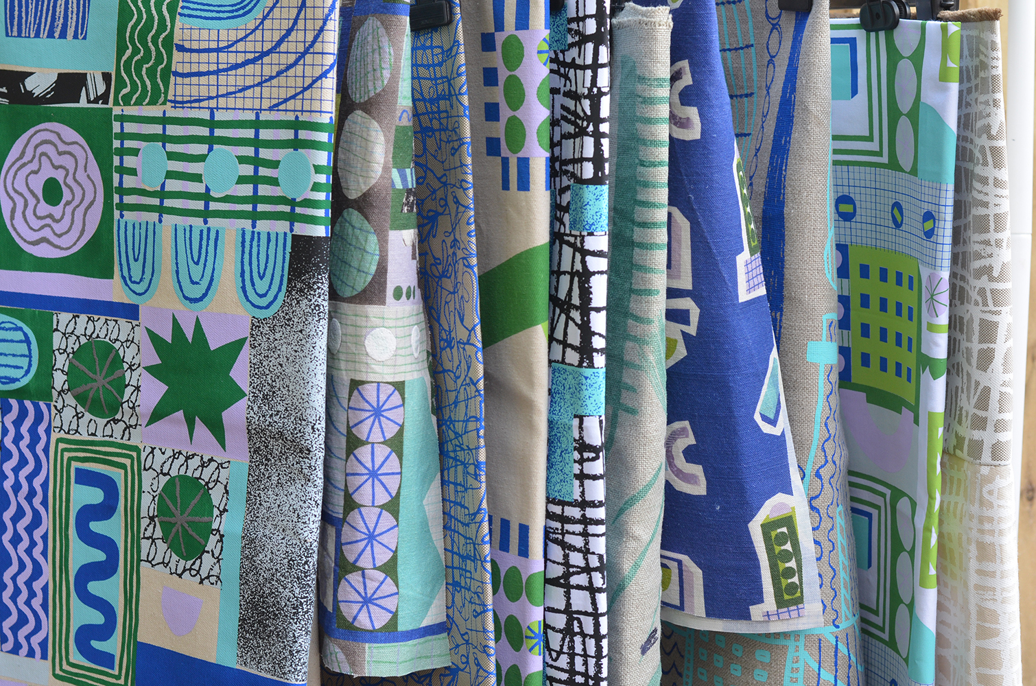 Blue, green, purple and white printed fabric designs