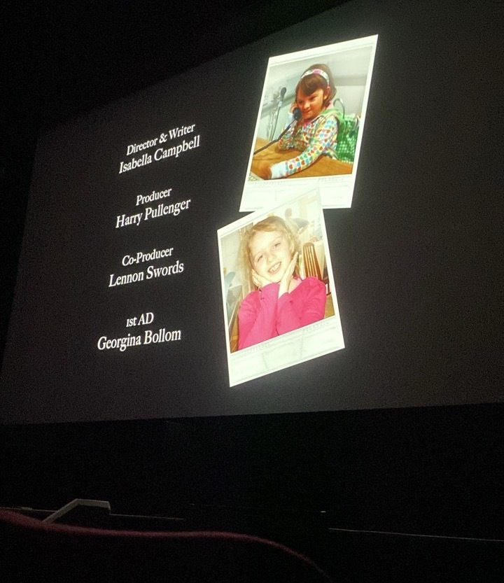 Film screening with credits and polaroid photos by the side.
