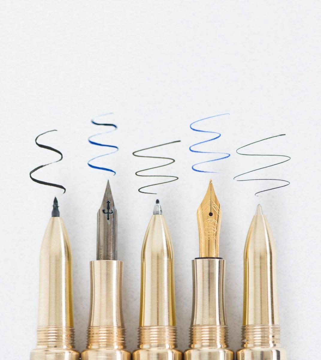 Five Toms Studio pens scribbling on a piece of paper