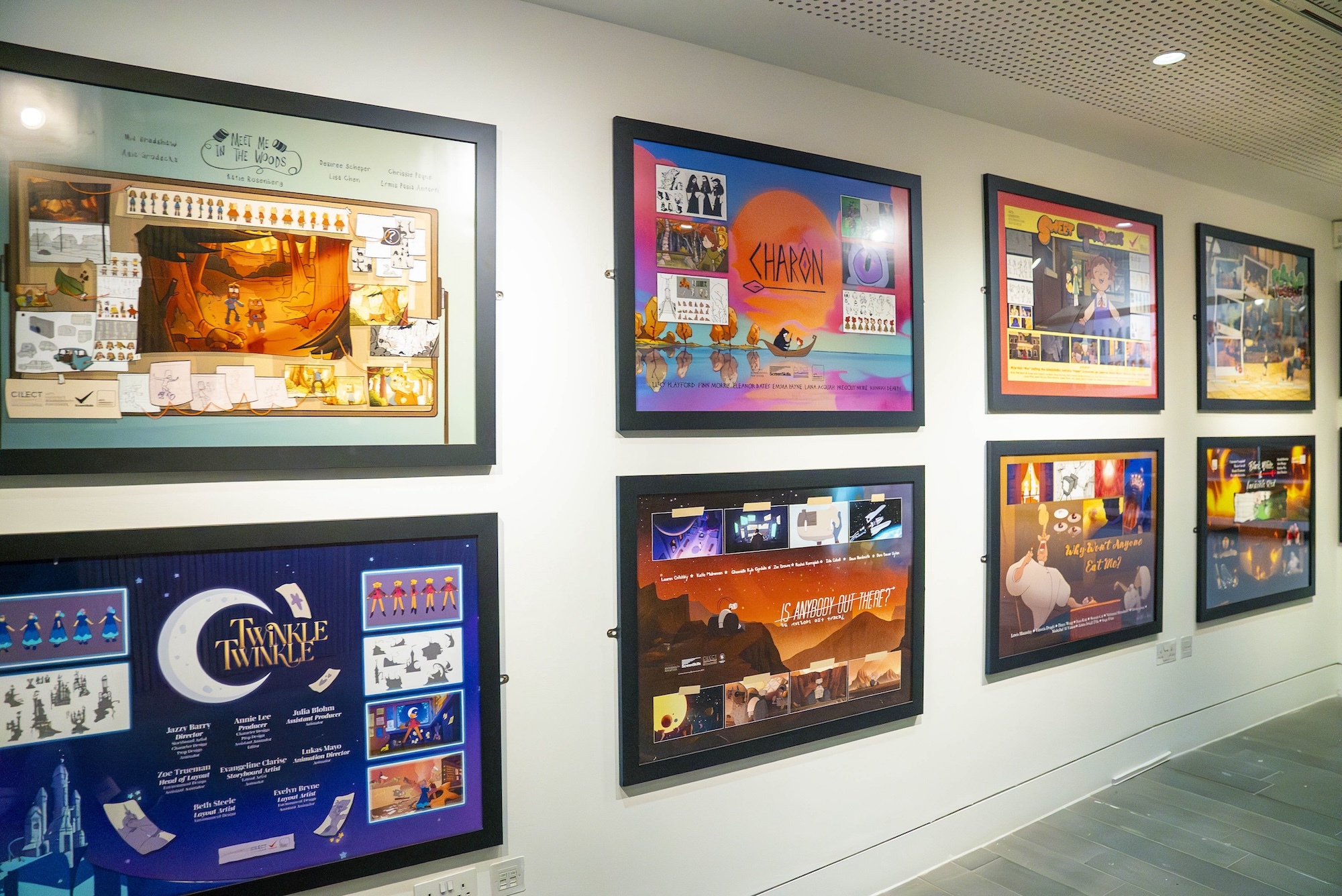 A wall of eight posters for films produced by BA (Hons) Animation Production students, in frames on display during AUB's 2024 Undergraduate Summer Shows.