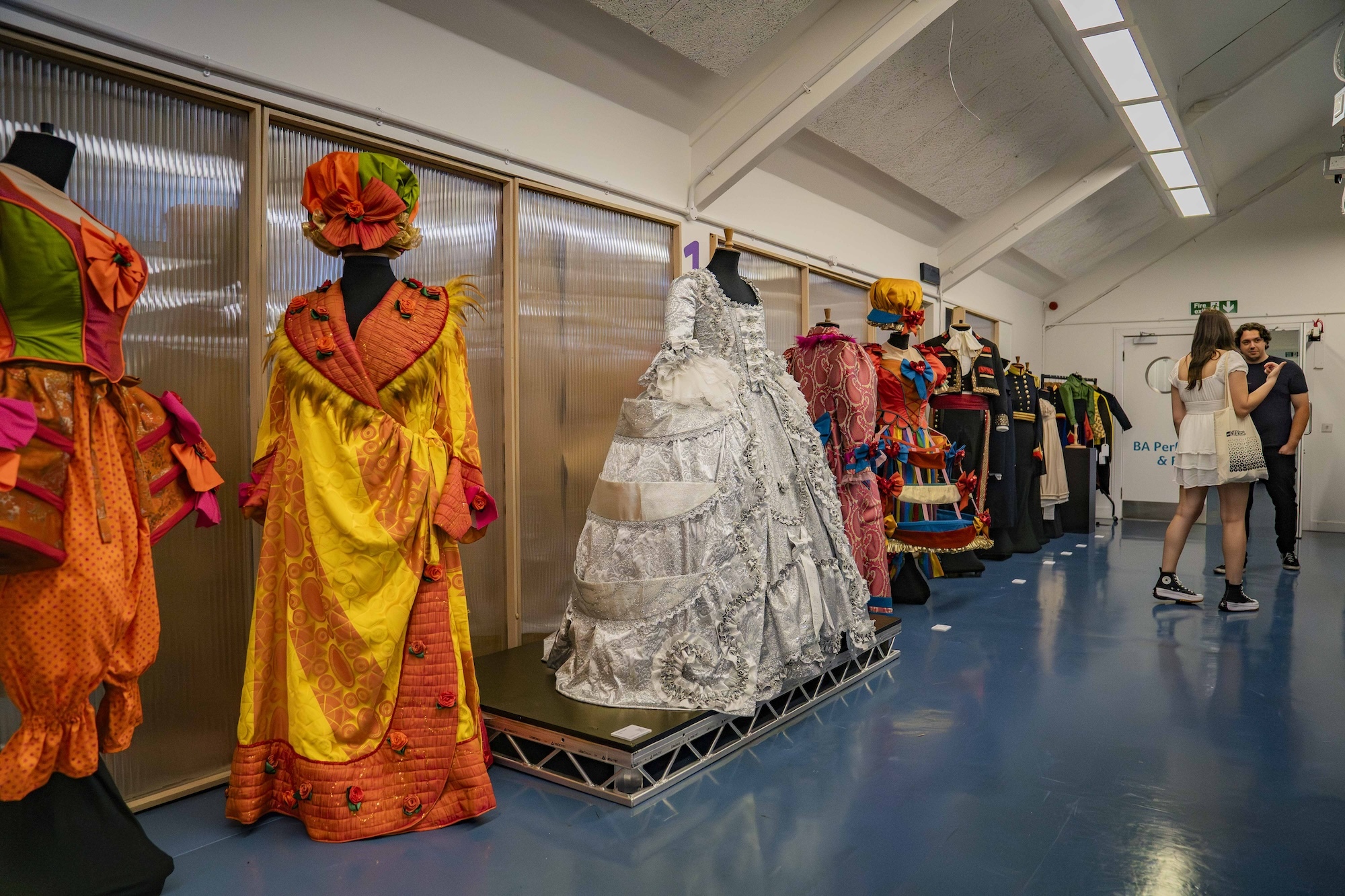 Various colourful and theatrical-style costumes on display on mannequins in a studio at Arts University Bournemouth during the 2024 Undergraduate Summer Shows.