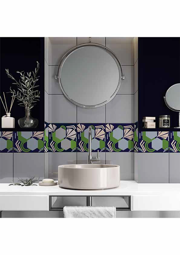 Modern bathroom with round basin, circular mirror, and decorative tiles featuring geometric patterns in navy, green, and pink.