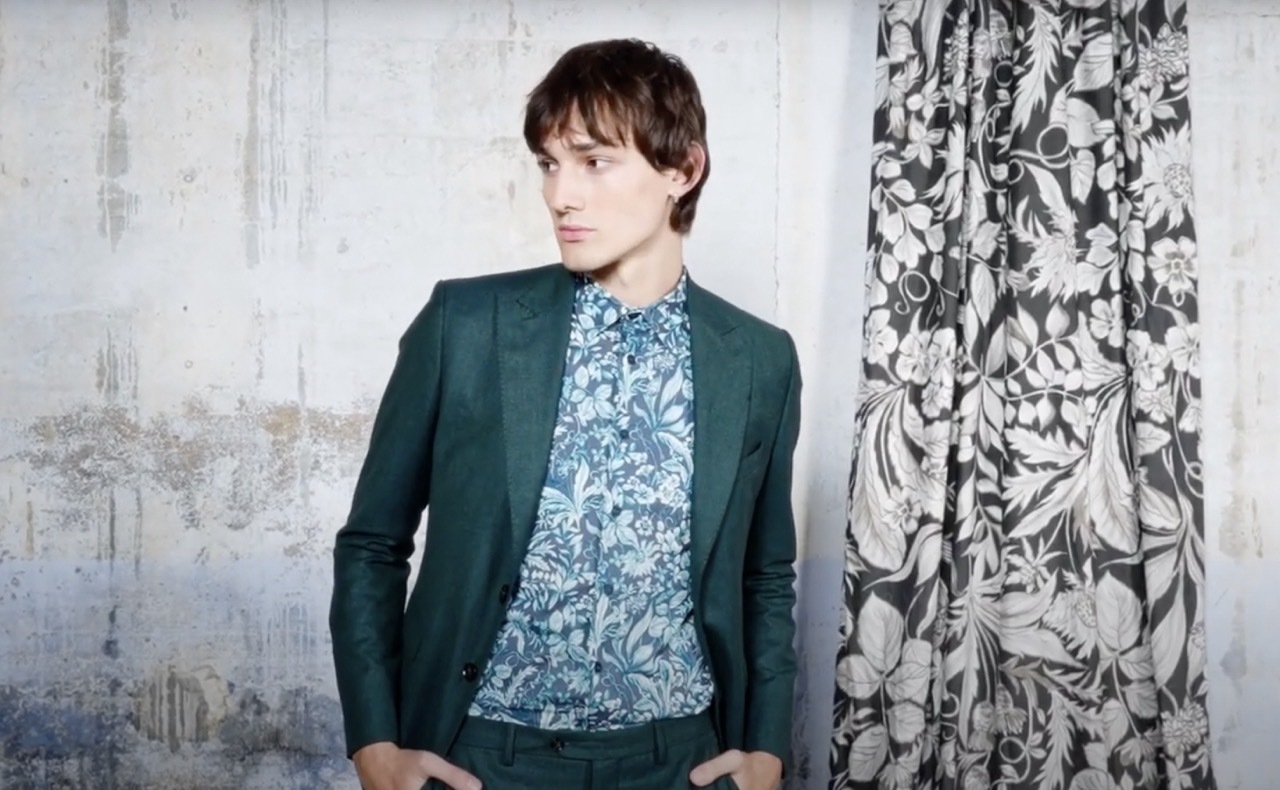 Male model in a floral green suit.