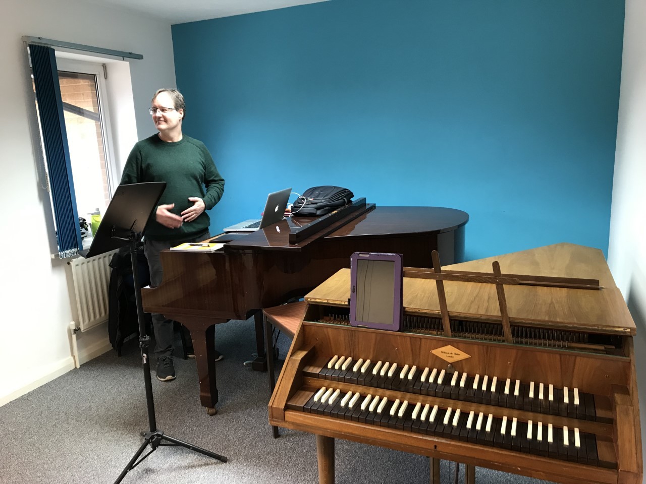 Person standing next to a piano