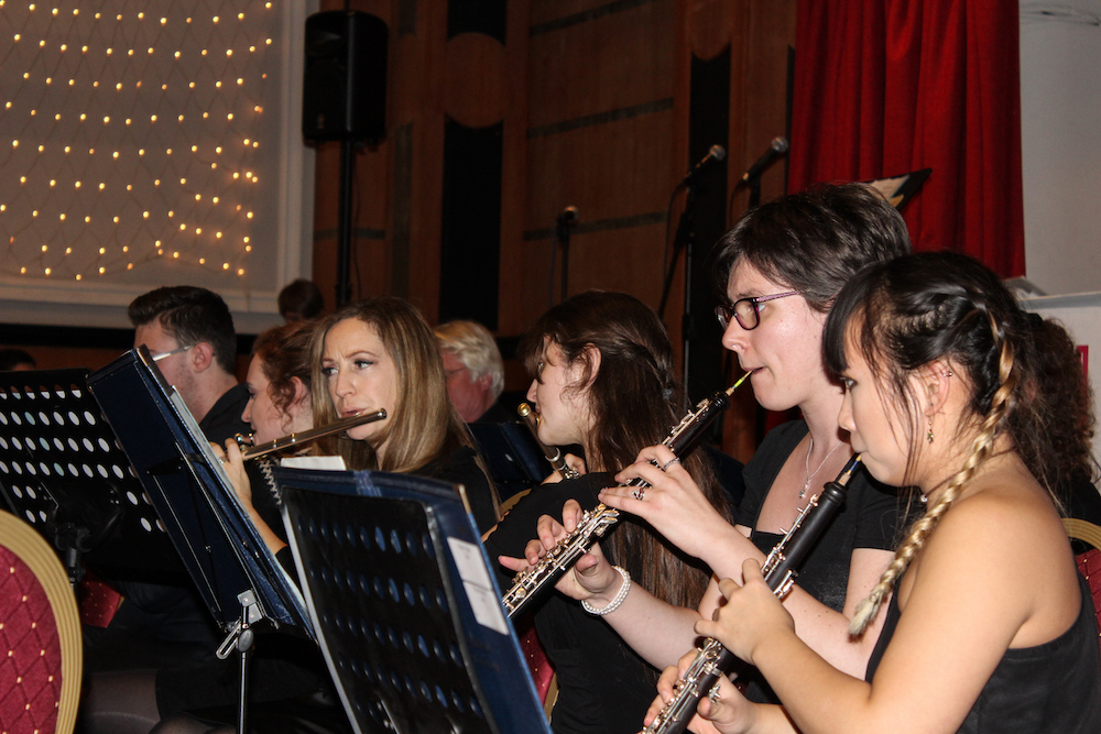 a number of University music students Music playing wind instruments in concert