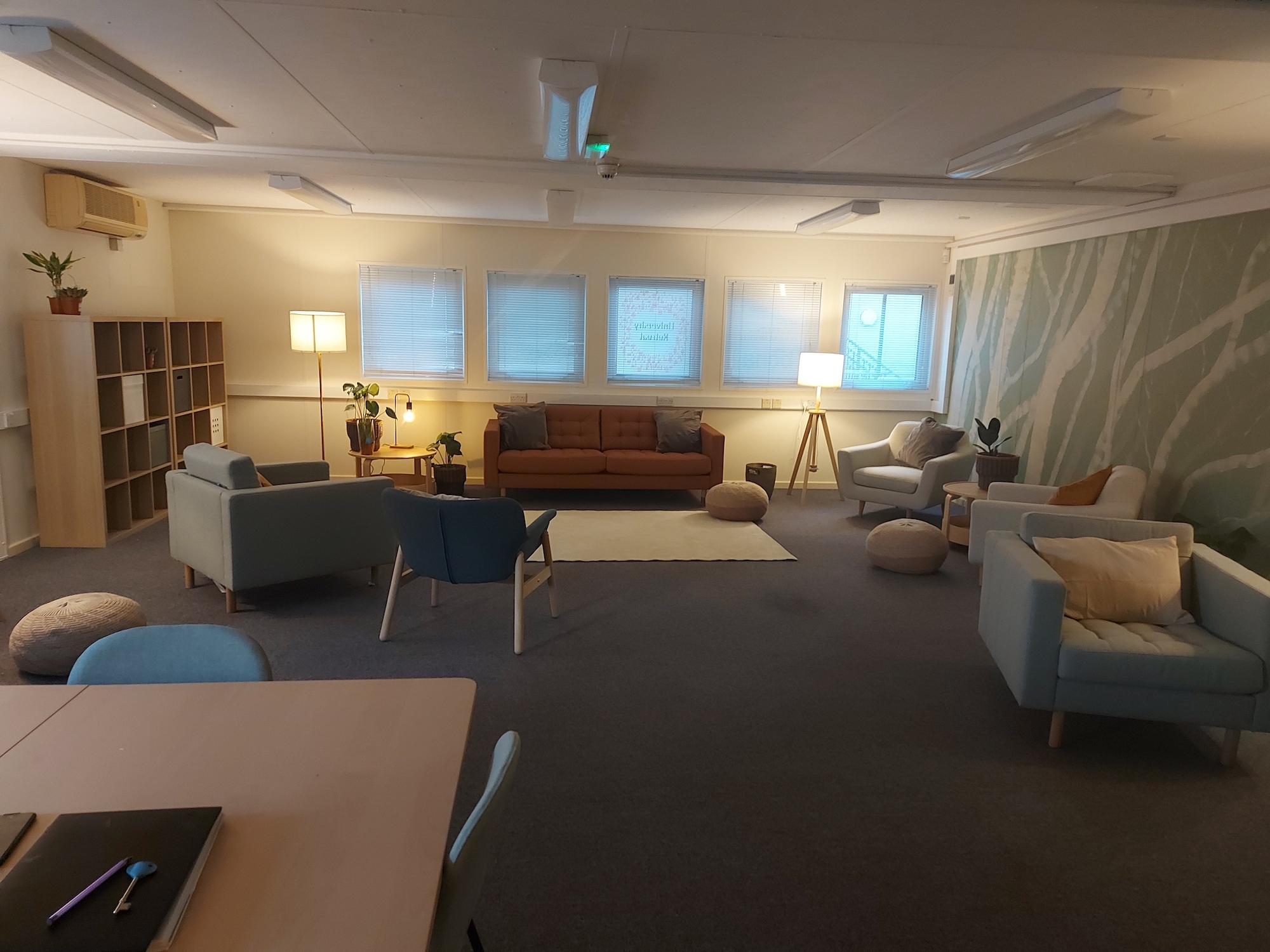 A large and well-lit living space with several sofas and chairs
