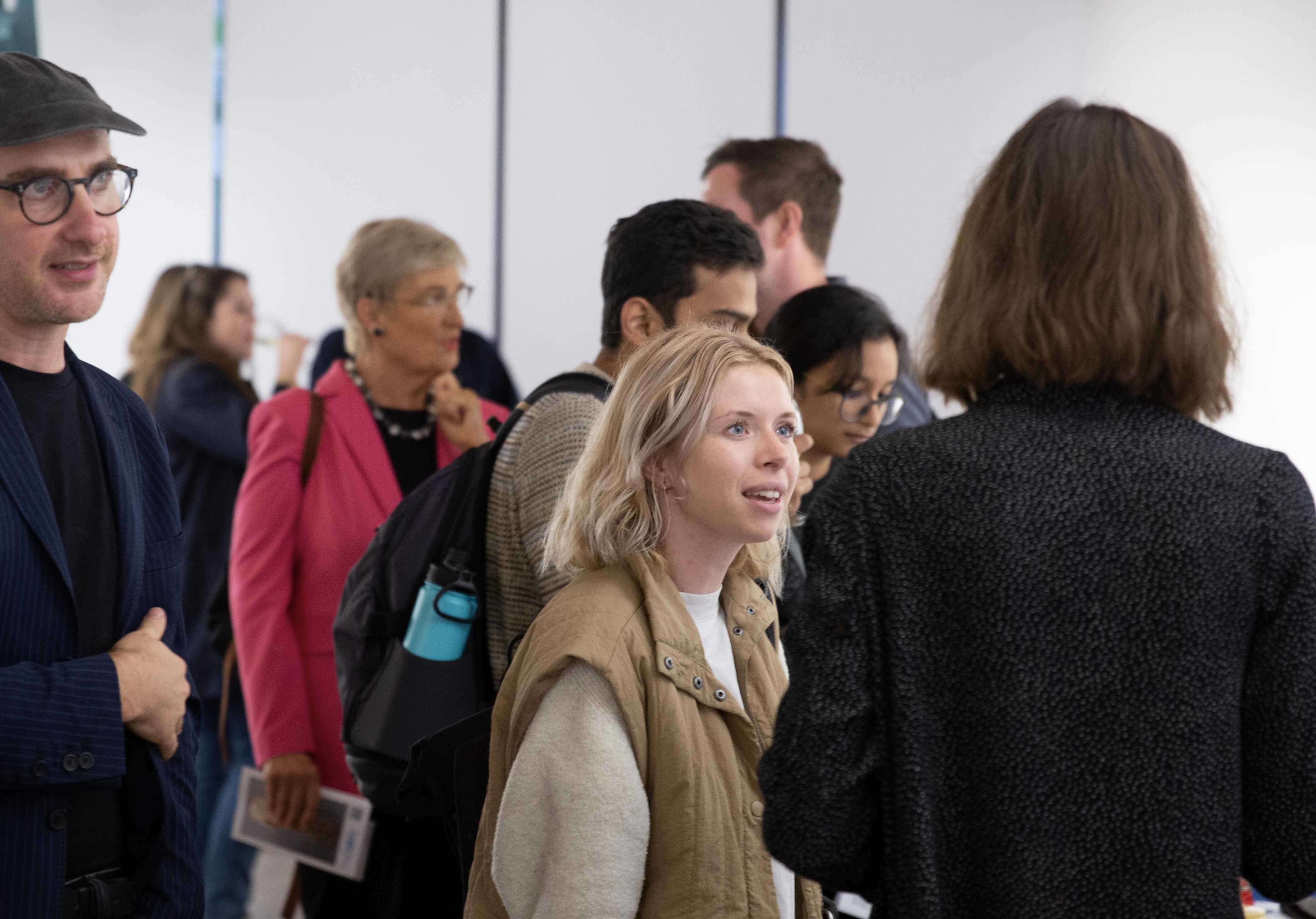 A group of visitors at a gallery exhibition.