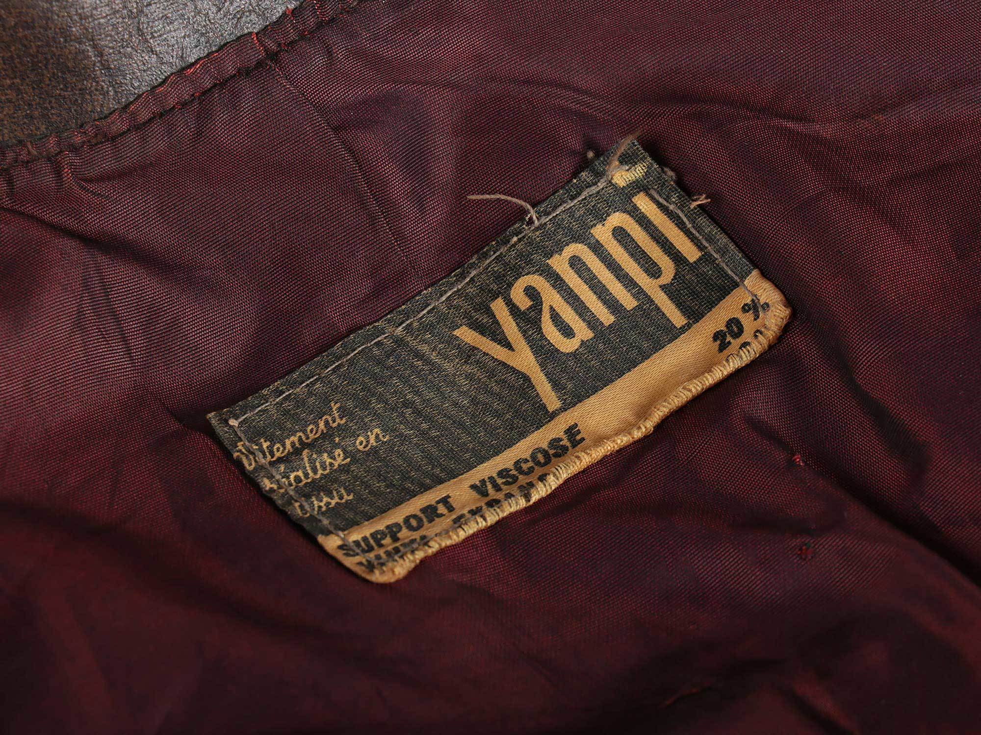 A close-up of the fake leather jacket clothing tag that reads "Yanpi"