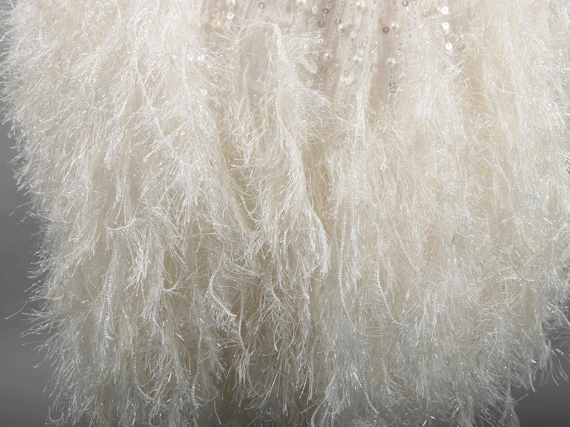 A white Faux feather trim dress close up