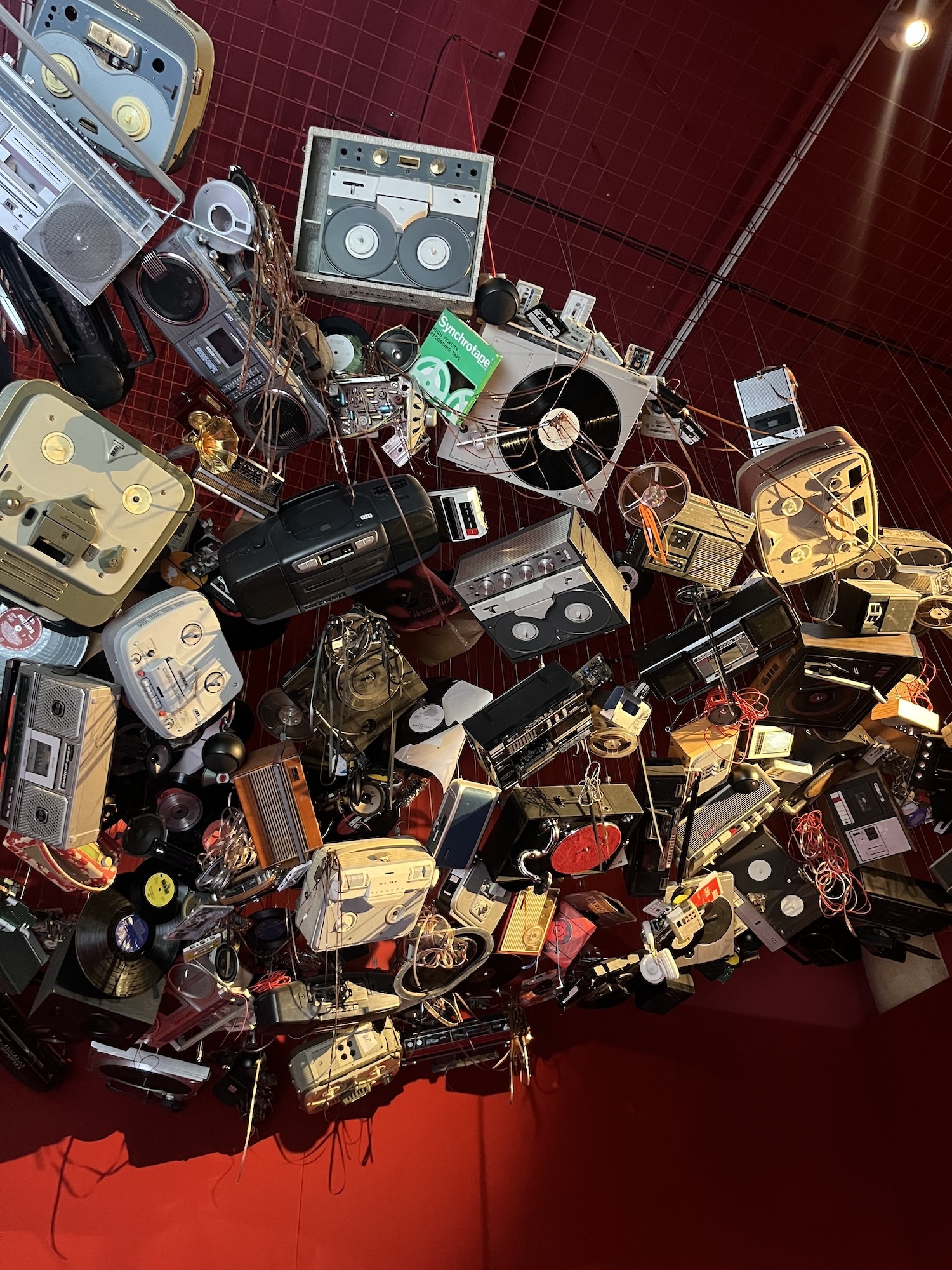 An abstract artwork consisting of an assortment of old radios and other audio equipment.