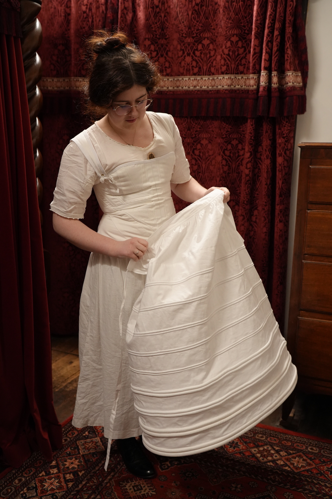 BA (Hons) Costume student V Joy examining a Regency era underskirt