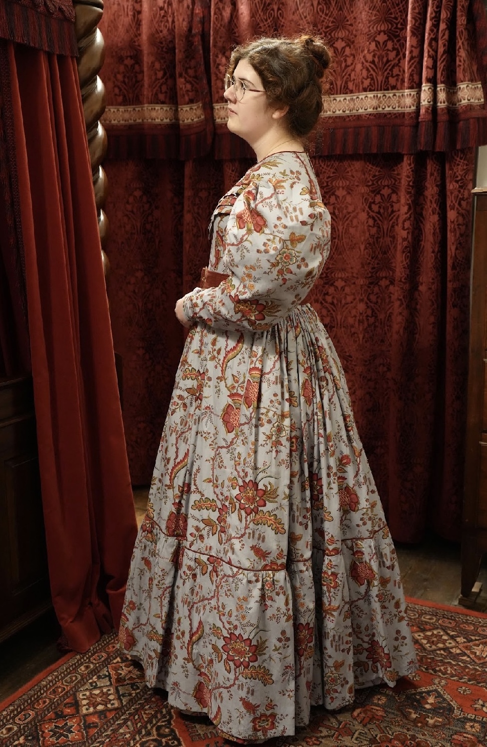 Singer and BA (Hons) Costume student V Joy in Regency era costume looking off to the left in a curtained room.