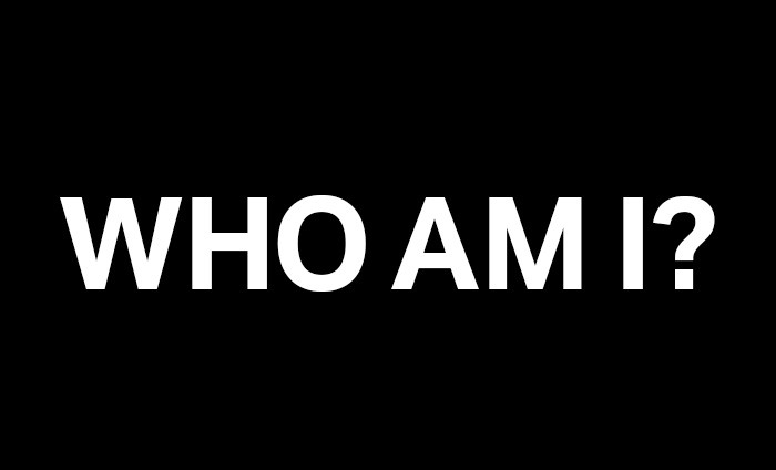 The words WHO AM I? appear on a plain black background