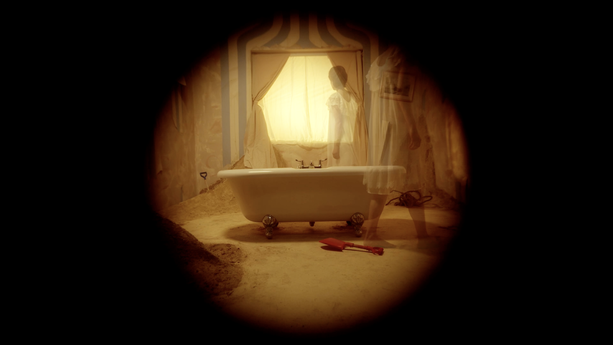 Circular vignette showing warm golden-lit bathroom interior with white bathtub, bright window, and brown/amber tones throughout.