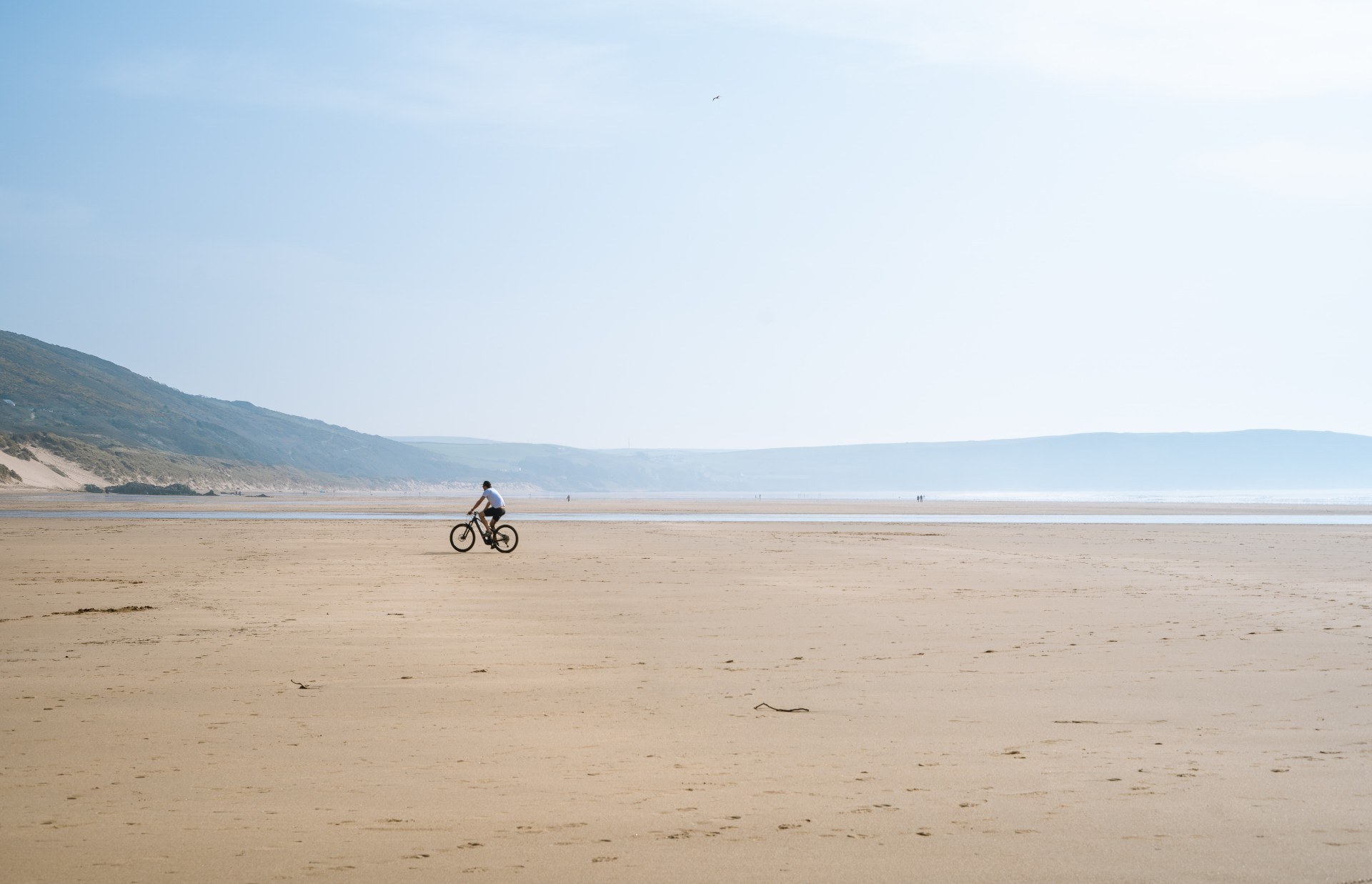 man on bike on the beach