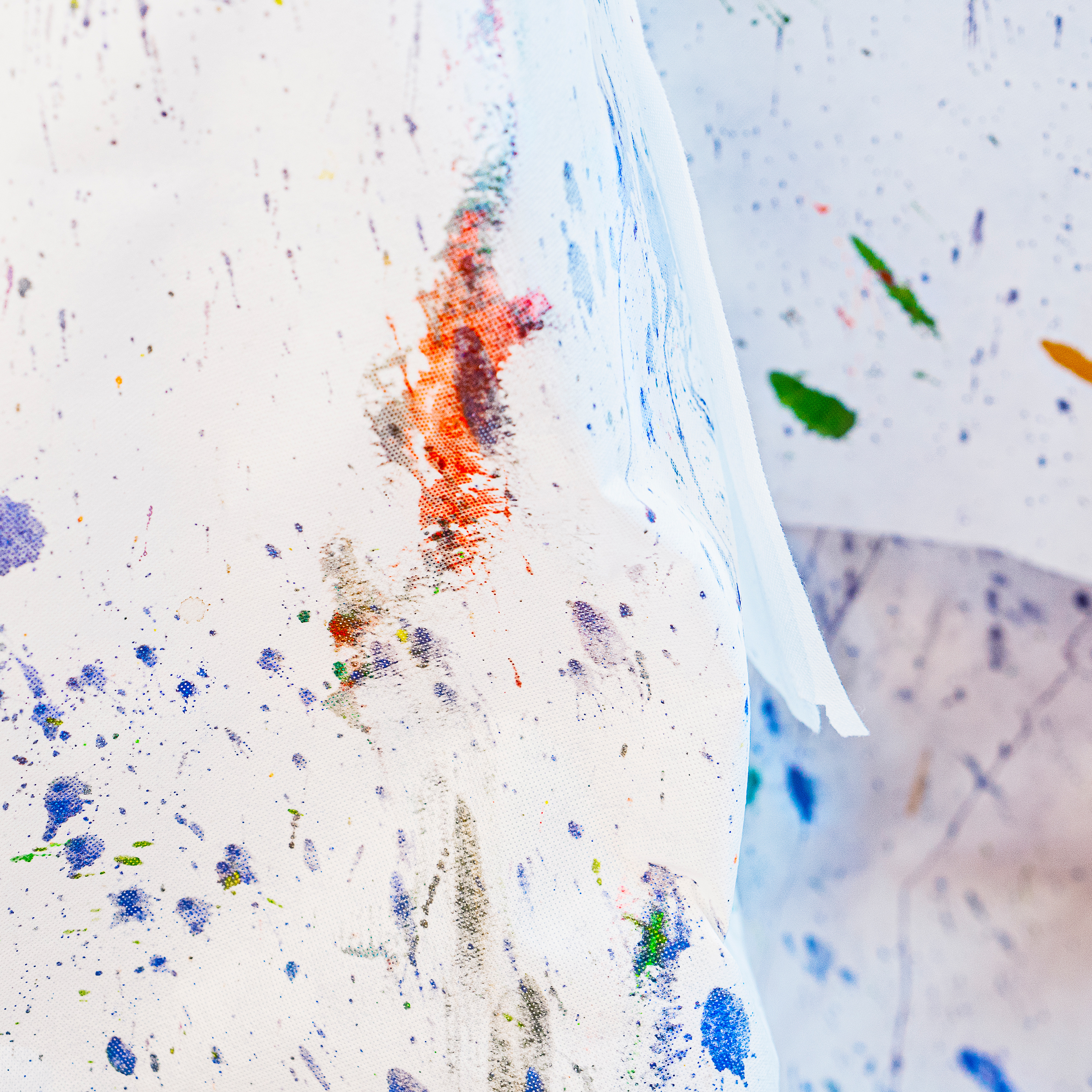 Abstract paint brushstrokes and spots on material.
