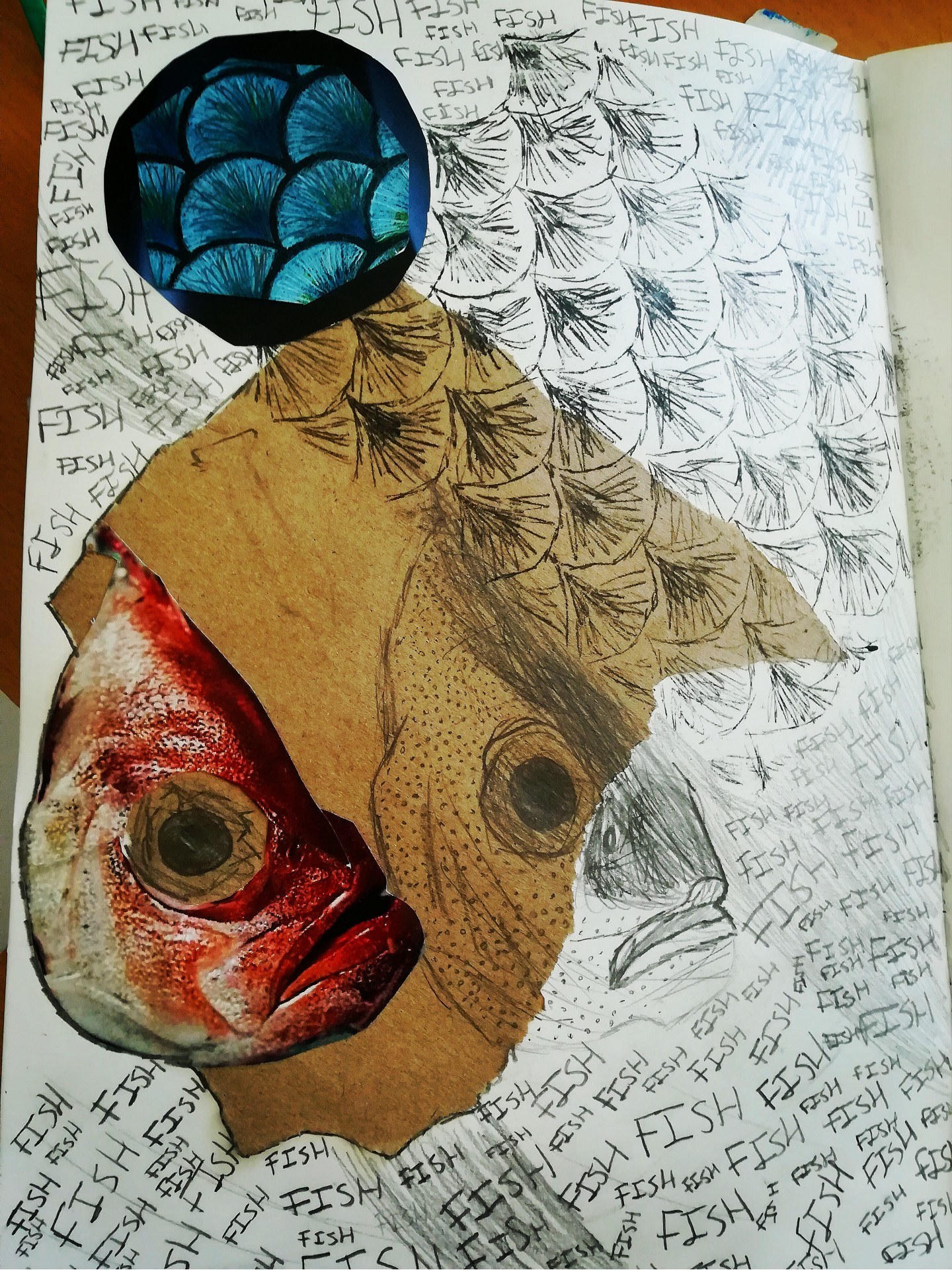 Page of a sketchbook with a print of a fish's head, fish scales and the word 'FISH' handwritten repeatedly at the top and bottom.