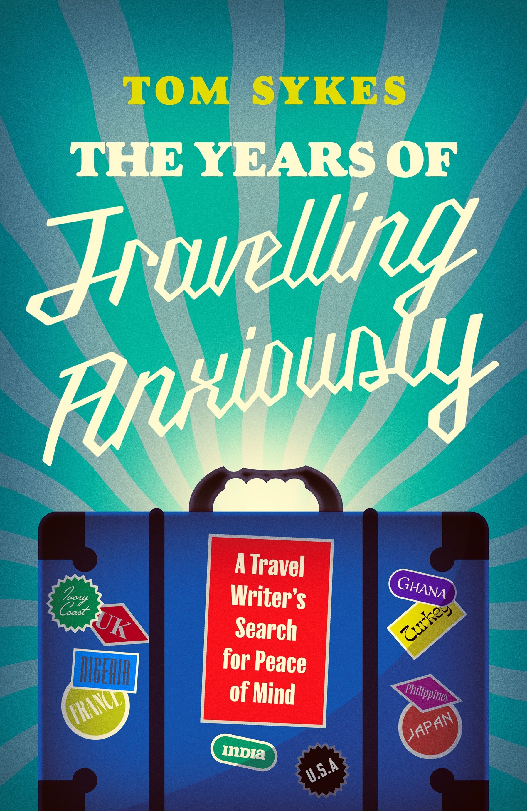 Book cover with turquoise sunburst background, yellow and white text reading 'Tom Sykes The Years of Travelling Anxiously', blue suitcase with travel stickers below