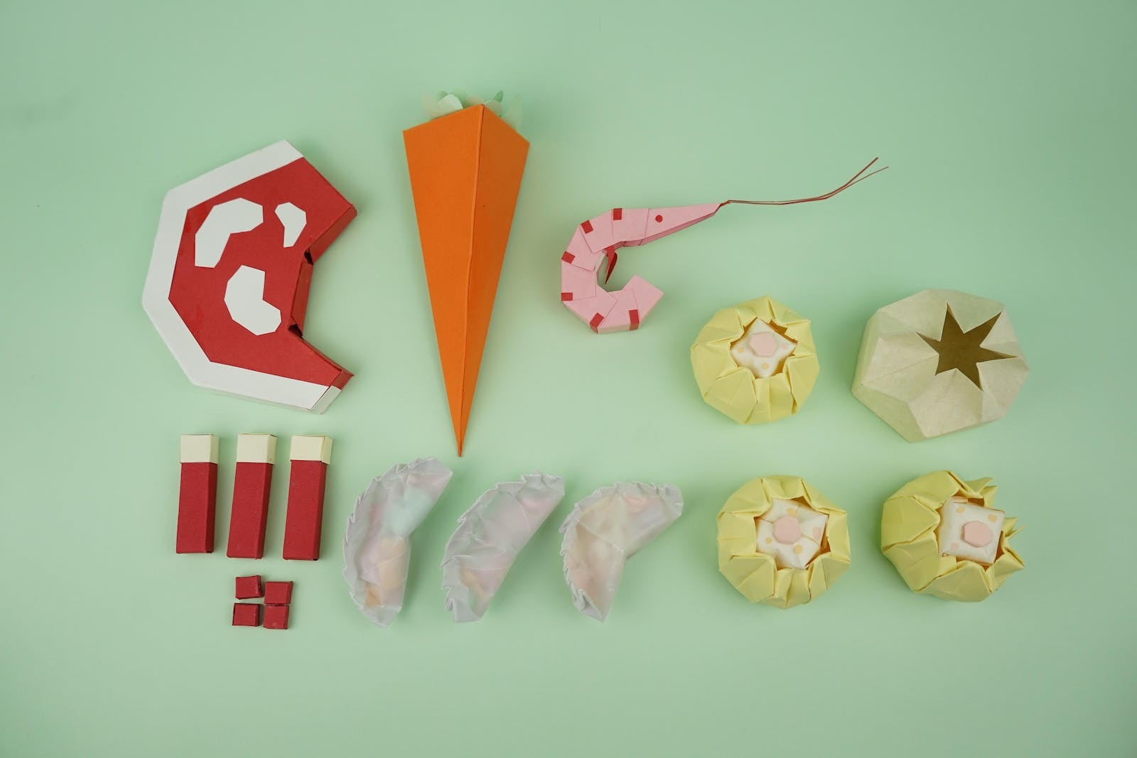 Paper models of food including prawns, gyoza, dumplings and meat