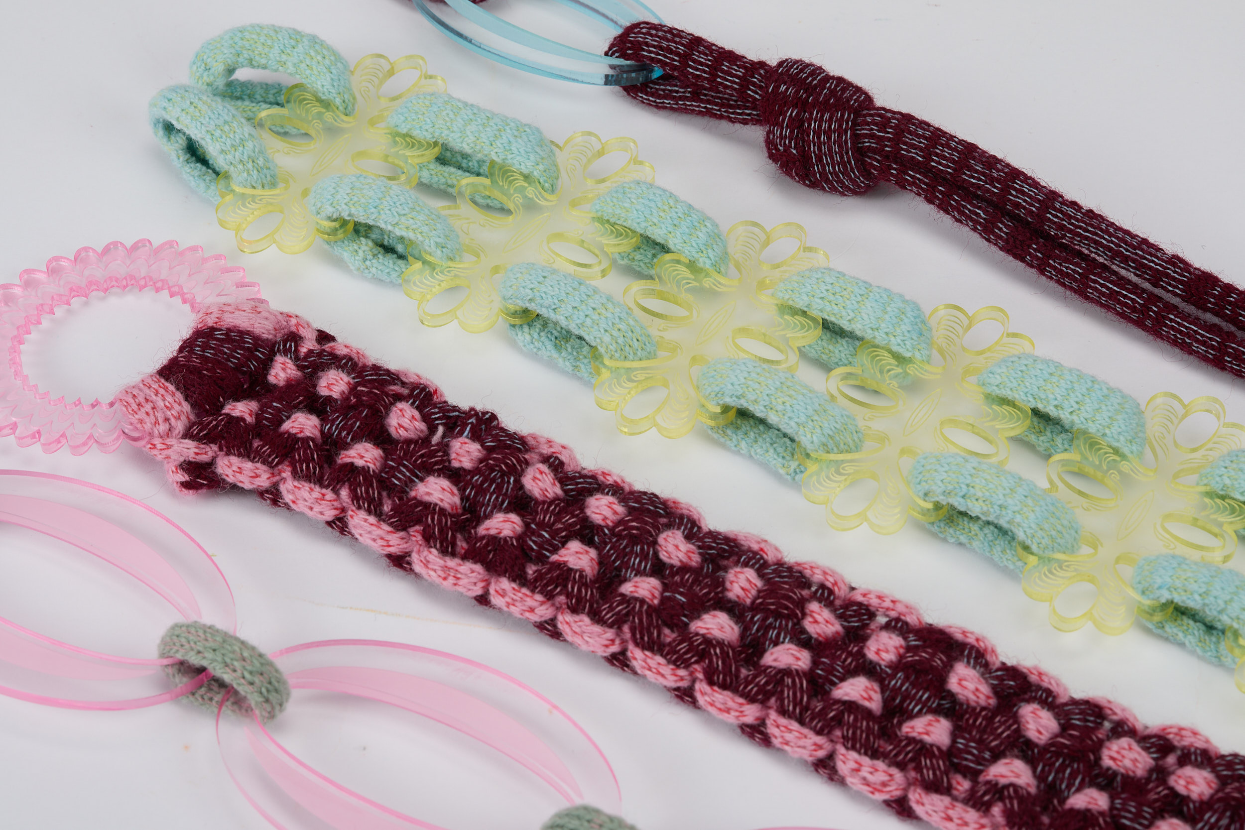 Close-up of four colourful braided textiles designs