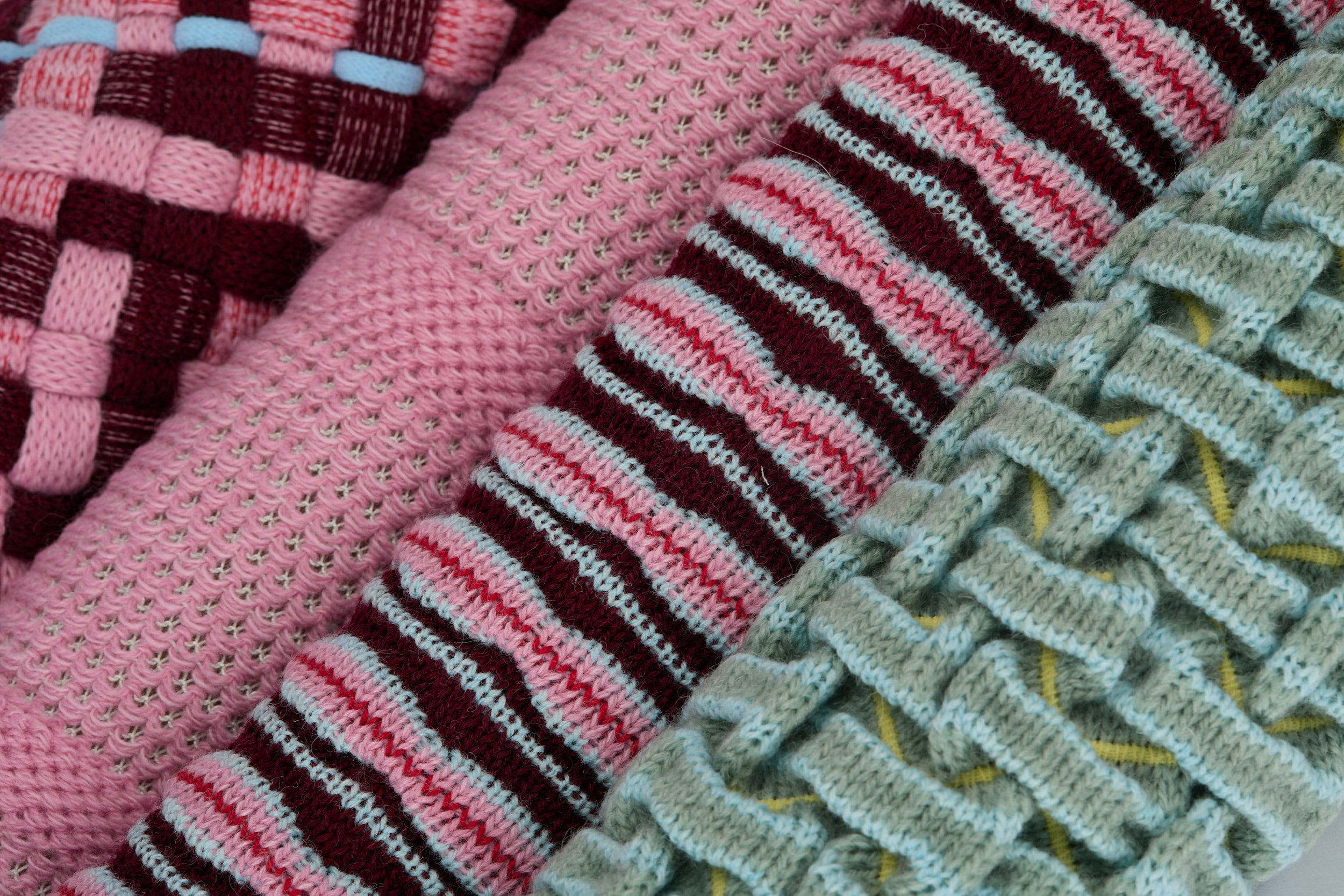 Close-up of four different knitwear-like textiles samples.