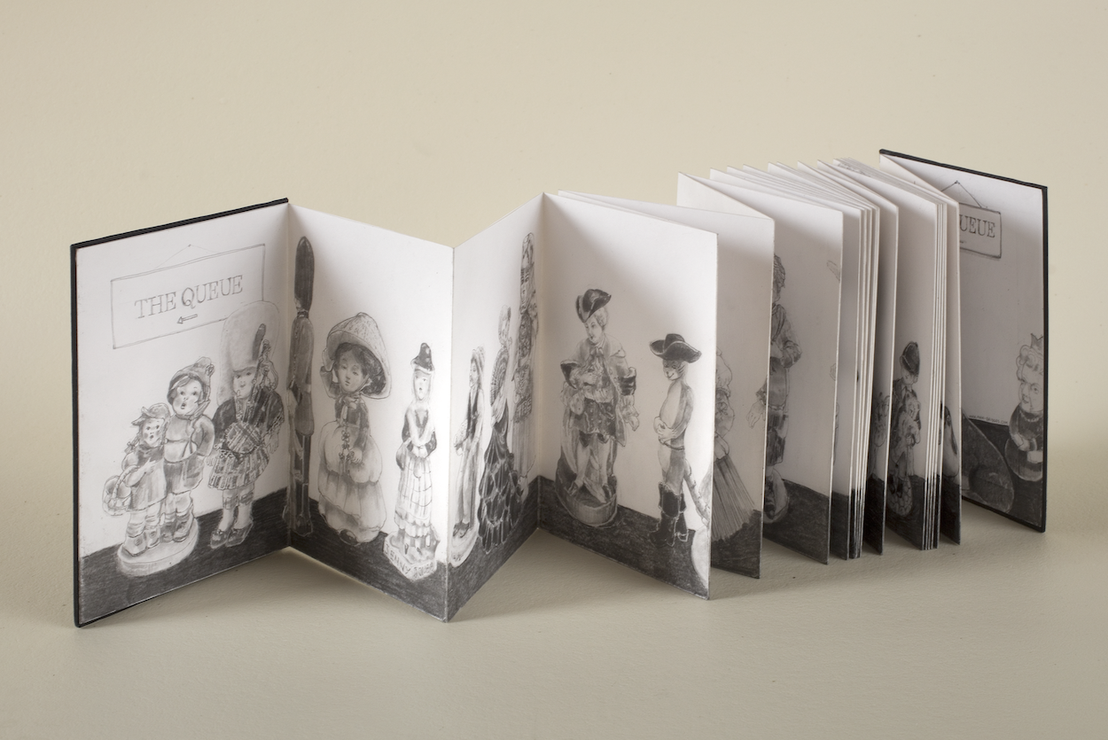 Illustrated flipbook partly unfolded with pencil illustrations visible at various points.