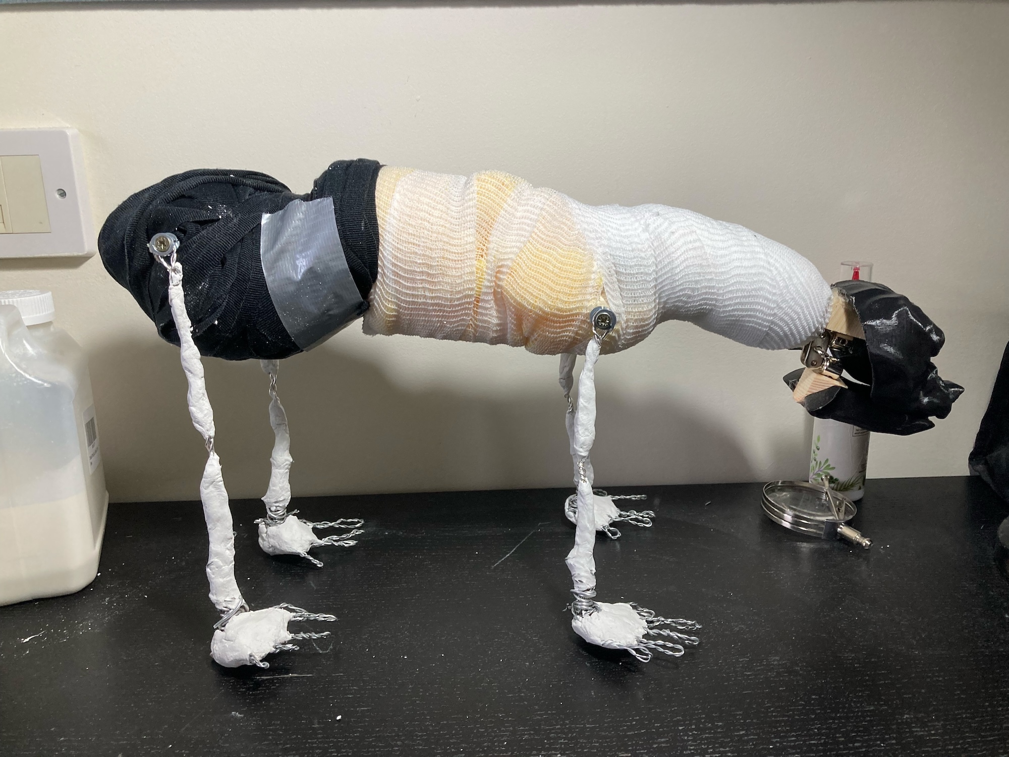 Person in black helmet and white striped jumper doing press-ups on dark kitchen worktop, white liquid dripping to floor.
