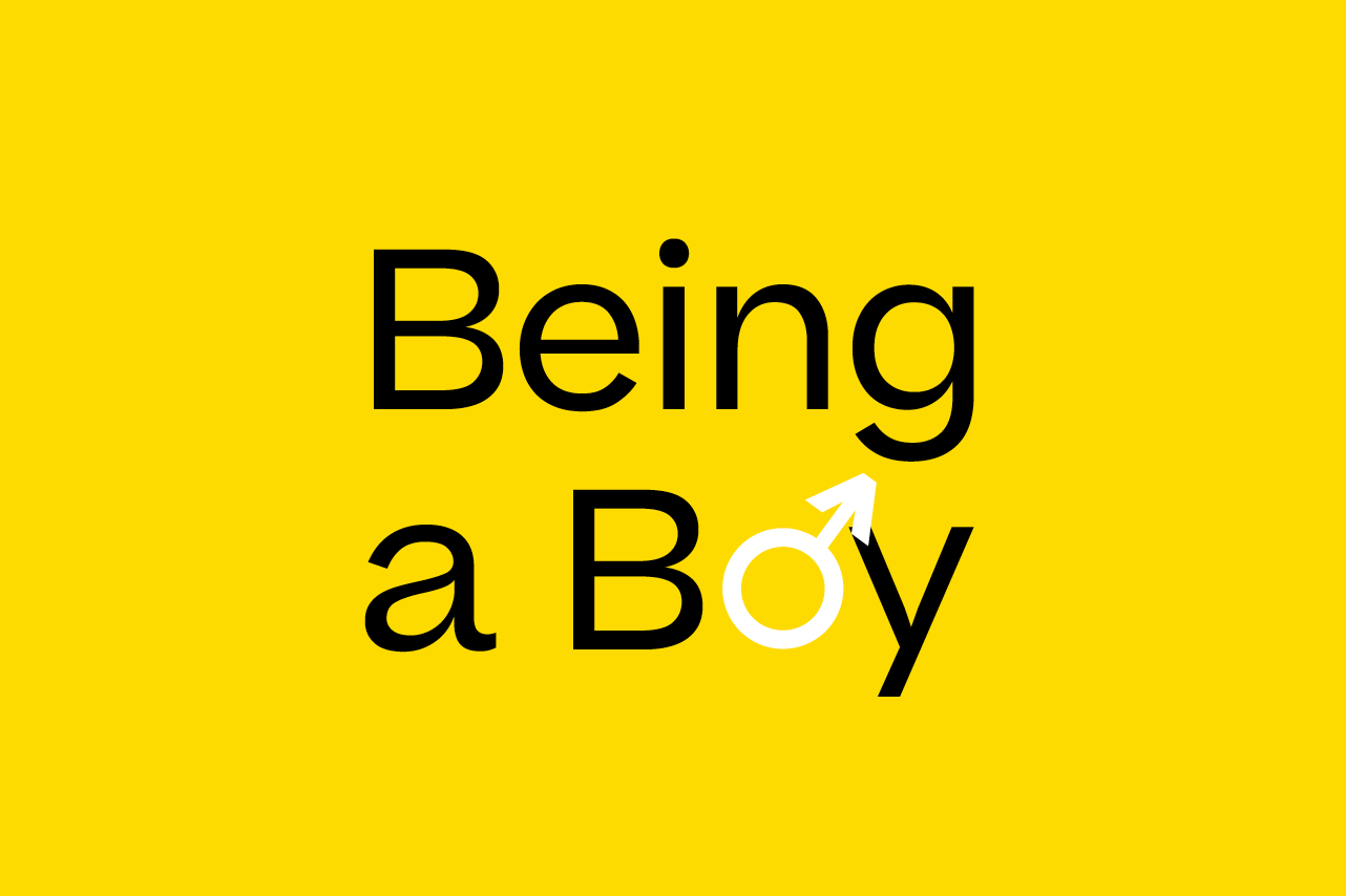 Yellow Banner with the text 'Being a boy'. The male gender symbol has been integrated into the word 'Boy'.