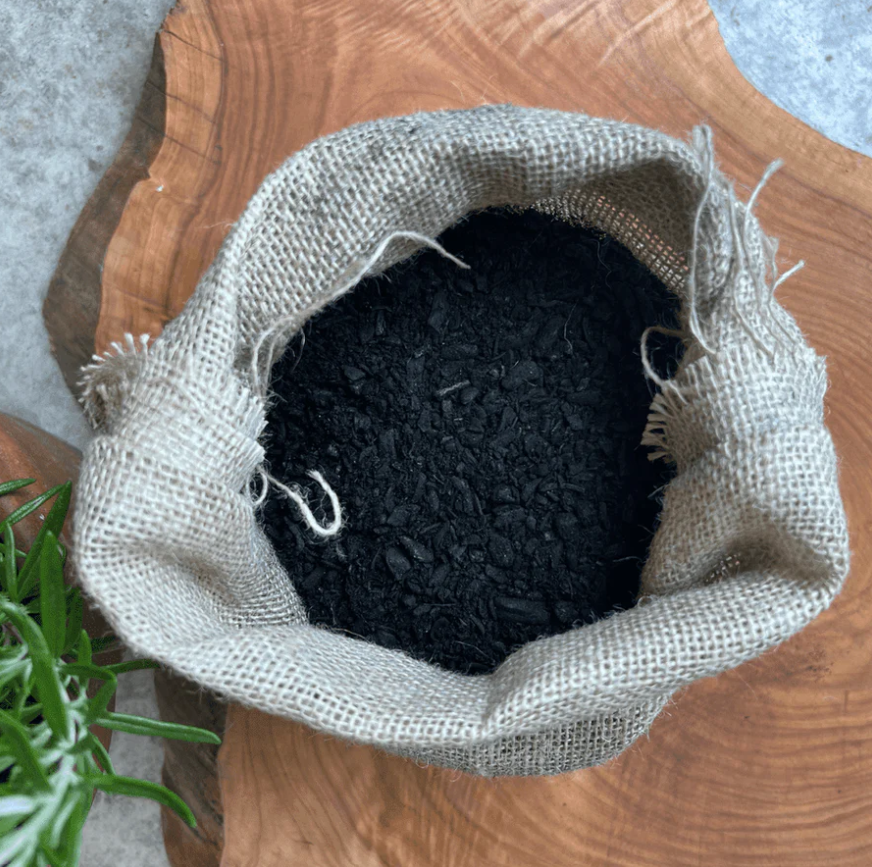 A hessian fabric bag full of biochar