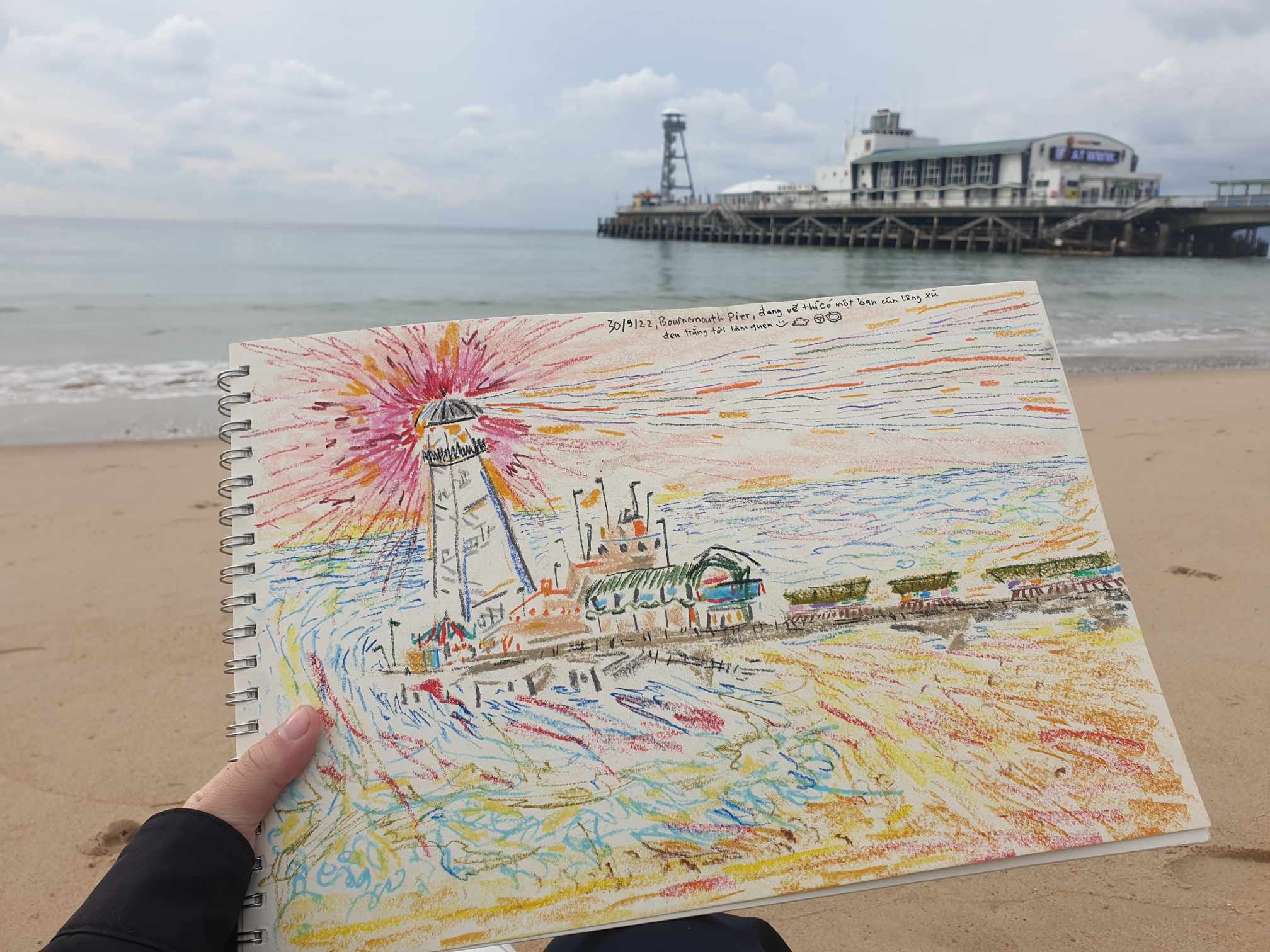 A colourful illustration of Bournemouth Pier with it in the background.