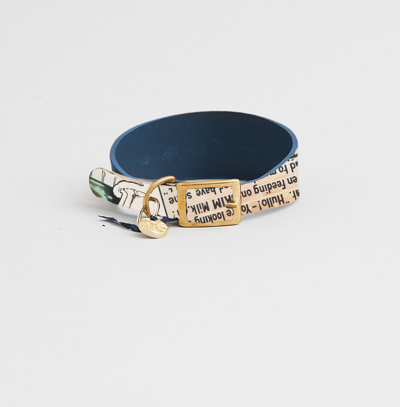 A fastened pet collar with a V&A design sits on a plain background.