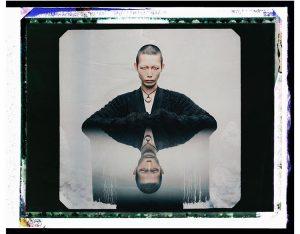 A digitally-edited image of a person reflected.